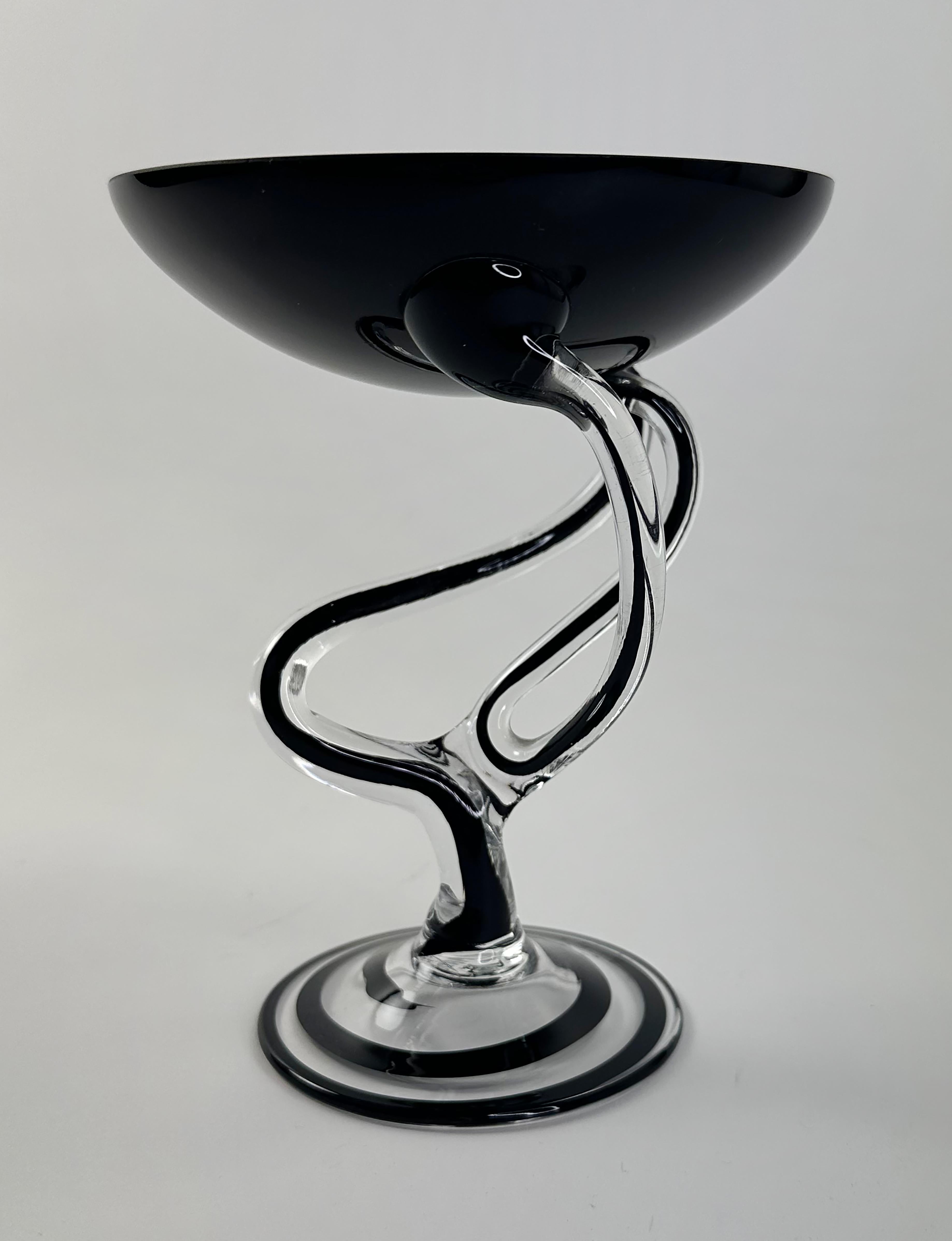 A handsome hand-blown Art Deco glass compote. In the style of a Jozefina Krosno glass sculptural bowl. Black and clear colors. Polish in Origin. This is similar to many of these types of glass sculptures as they tend to follow an “octopus” leg