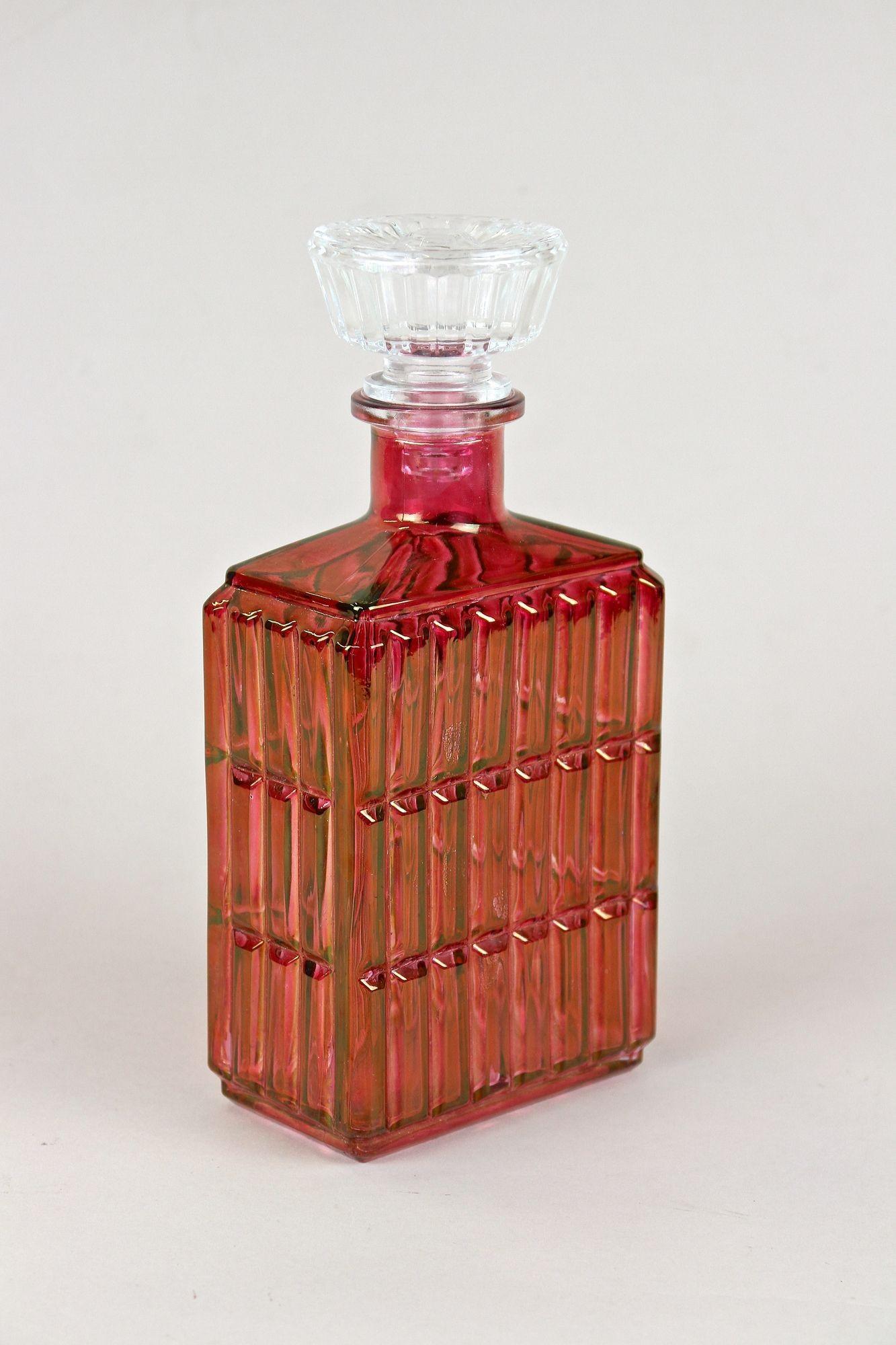 Fantastic looking Art Deco glass decanter or liquor bottle from the period around 1930 in Austria. An absolute beautifully crafted bottle made of red colored glass. This highly decorative piece of Austrian glass art impresses with a timeless, modern