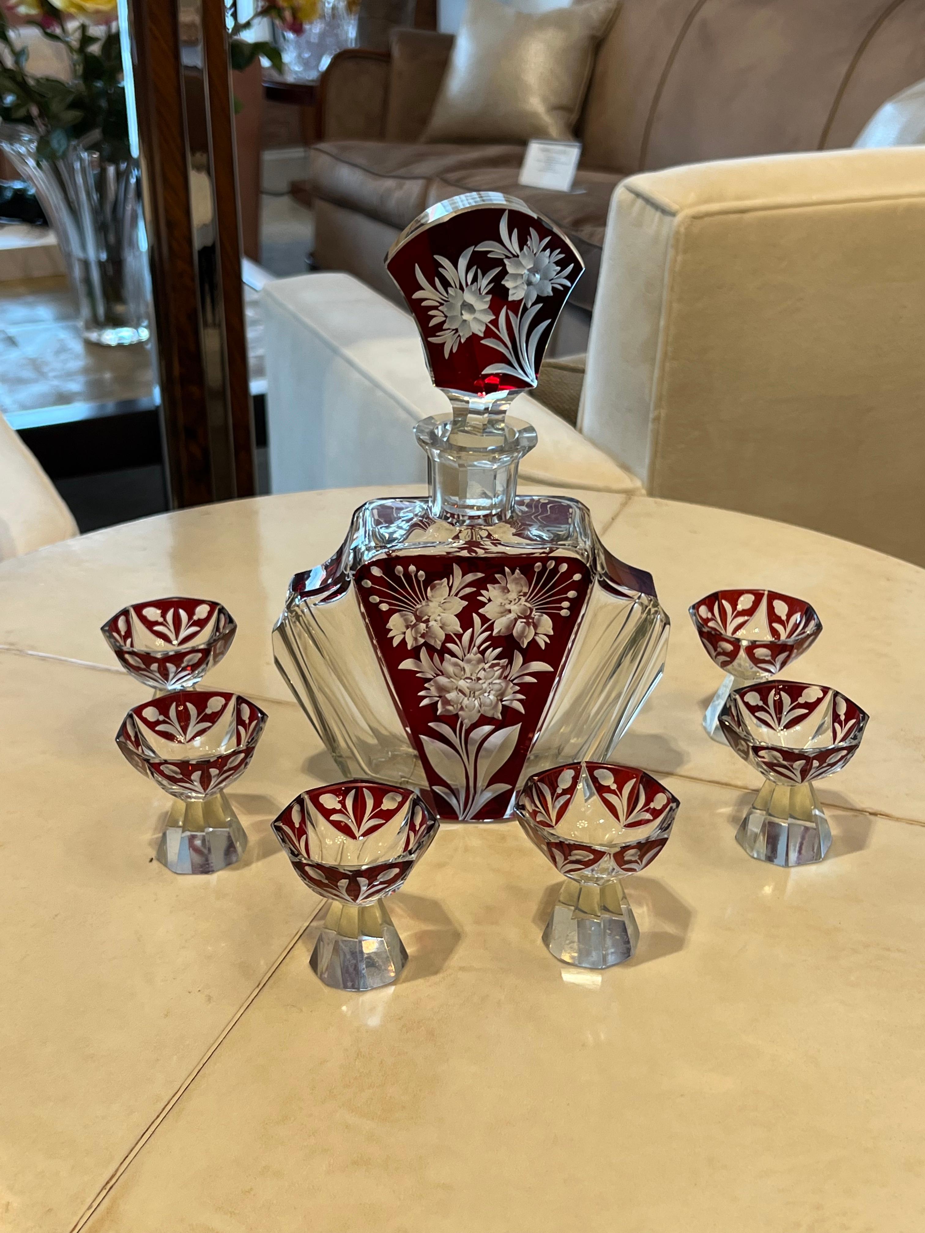 A beautiful Bohemian Art Deco glass with Red enamel details decanter set that includes 6 shot glasses. in the style of Karl Palda.