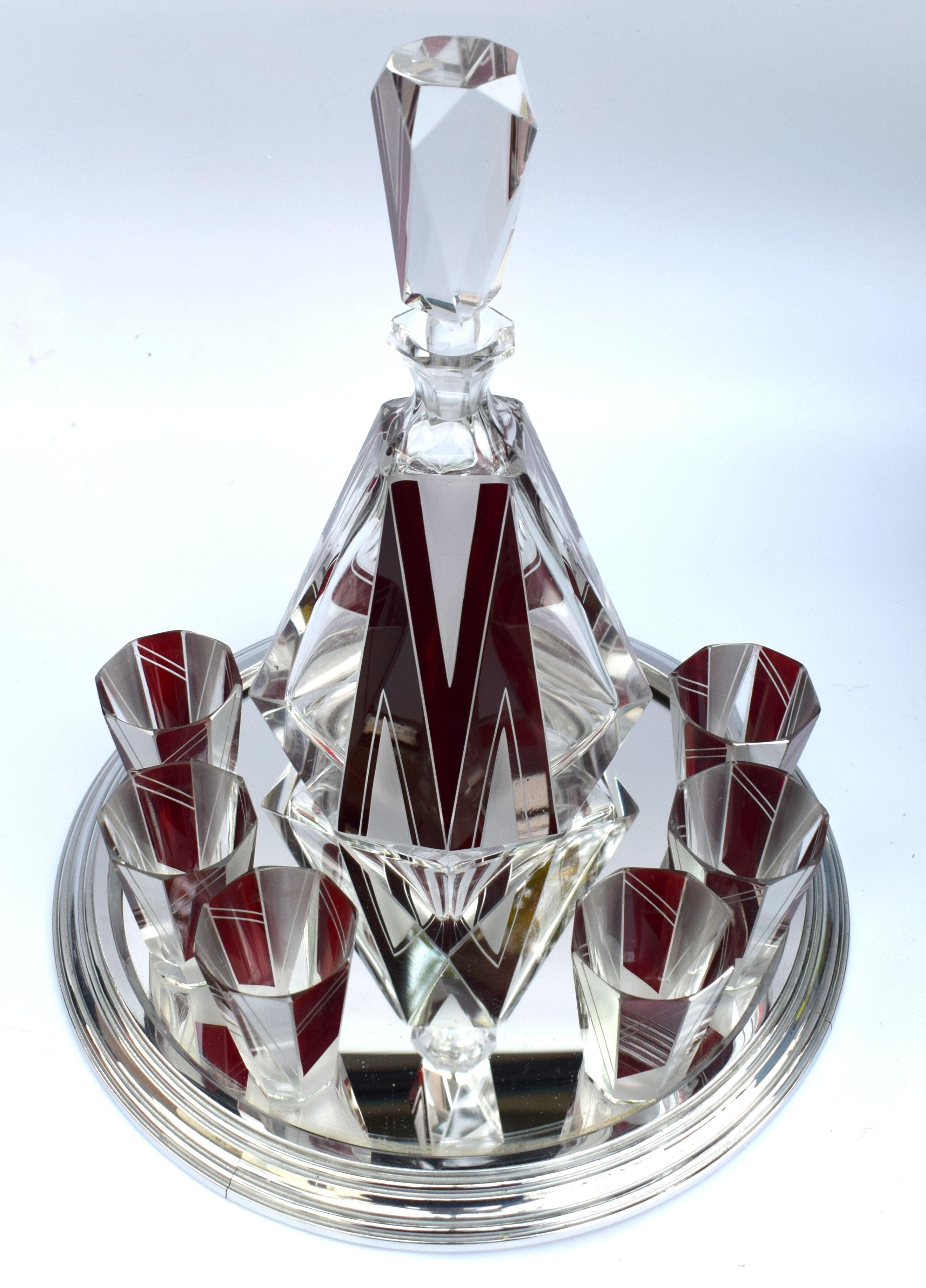 Wonderfully stylish glass decanter dating to the 1930s with a strong vibrant enameling in ruby red and silver overlay, this set really does stand out from the rest. Stunning shape and cut, small shot glasses. Comprises decanter and stopper with 6