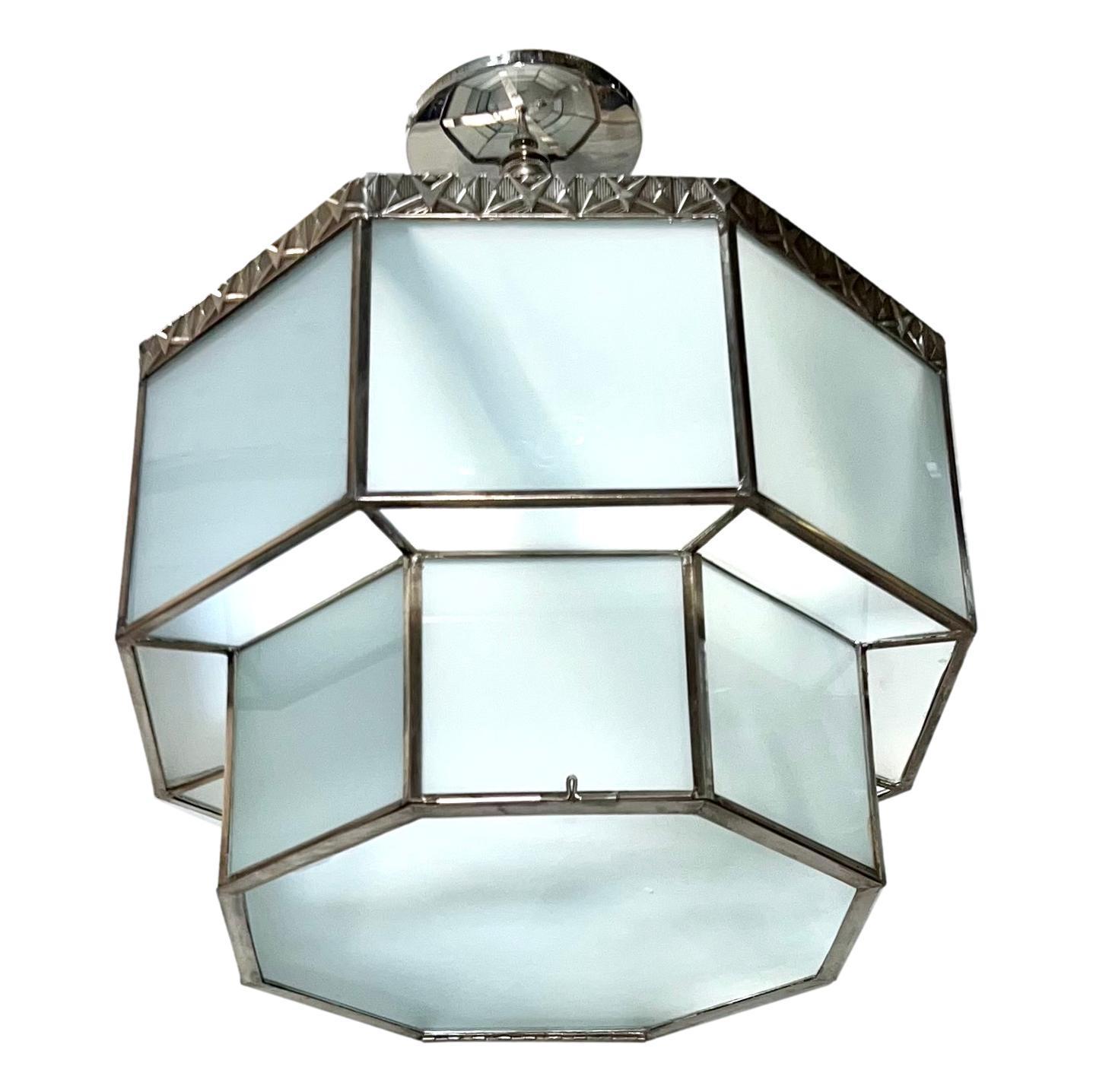 An octagonal circa 1940's French silver-plated and frosted glass light fixture with 4 interior lights.

Measurements:
Drop: 19