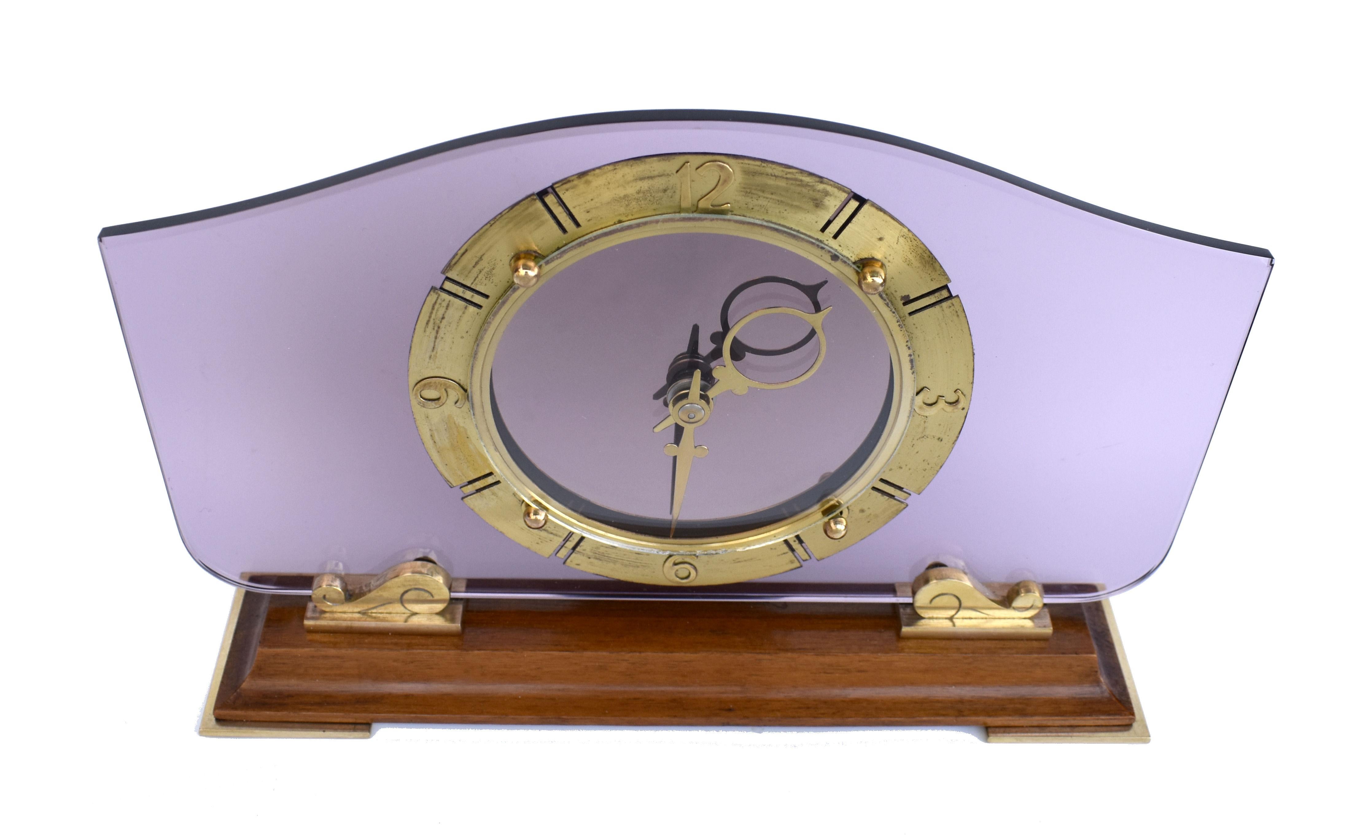For your consideration is this superb Smiths glass & mirror 8 day clock in fully serviced condition.
The frame is constructed from a moulded wooden base standing on flat gilt brass pads and the 5mm thick tinted plate glass with wave shape gilt