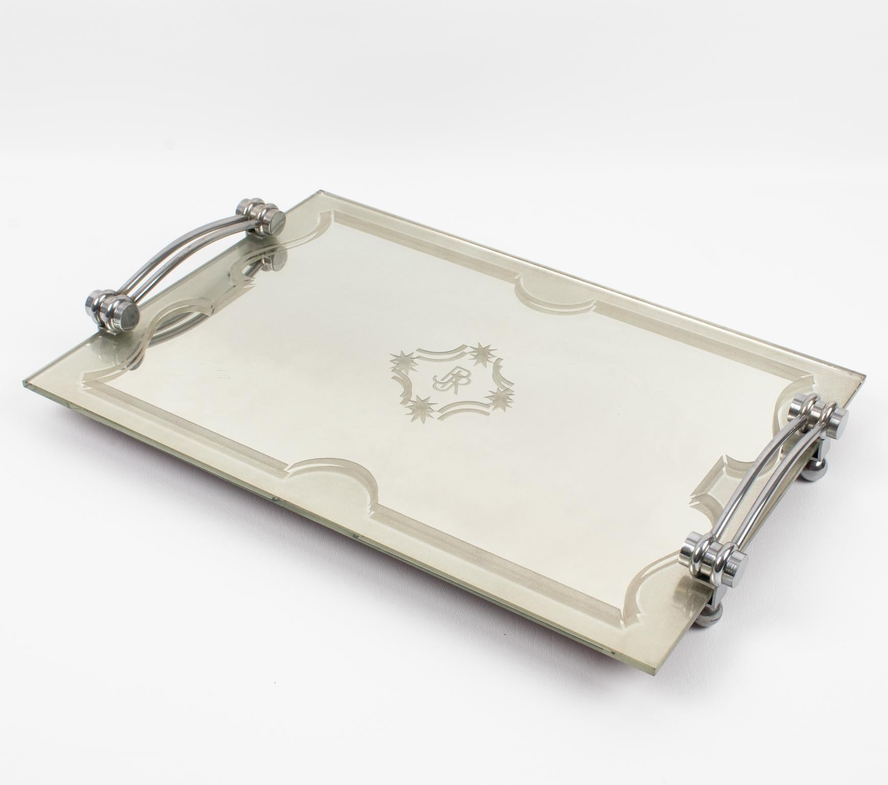 This lovely French Art Deco chromed metal and mirror tray features a thick mirrored glass slab with a frosted geometric design all around and a monogram engraved in the center reading 