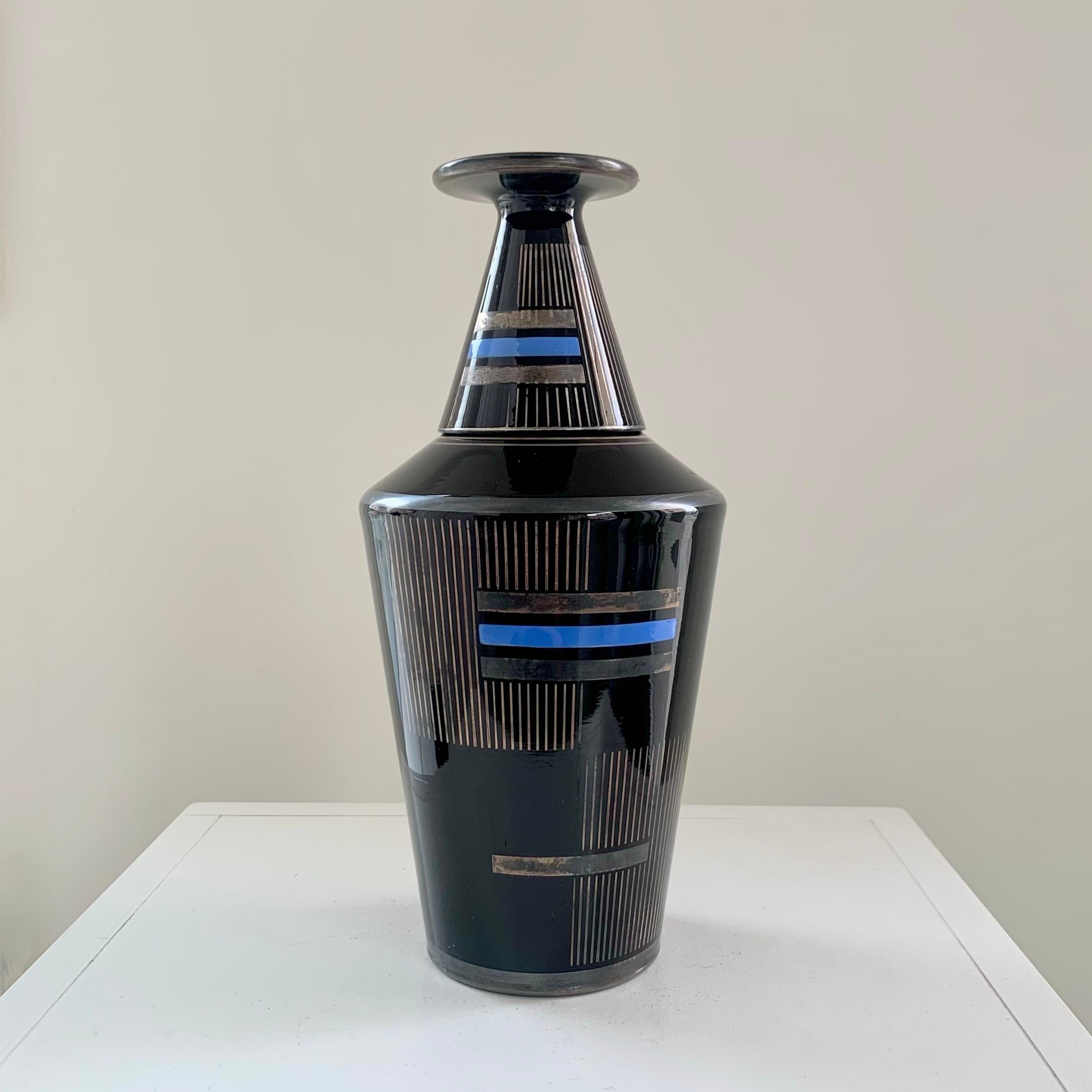 Rare Art Deco nightstand water carafe and his glass, circa 1930, France.
The glass is the cap of the bottle.
Black glass and geometrical silver and blue lines decor.
Dimensions: 24 cm total height, 11 cm diameter.
Original condition. 
All purchases