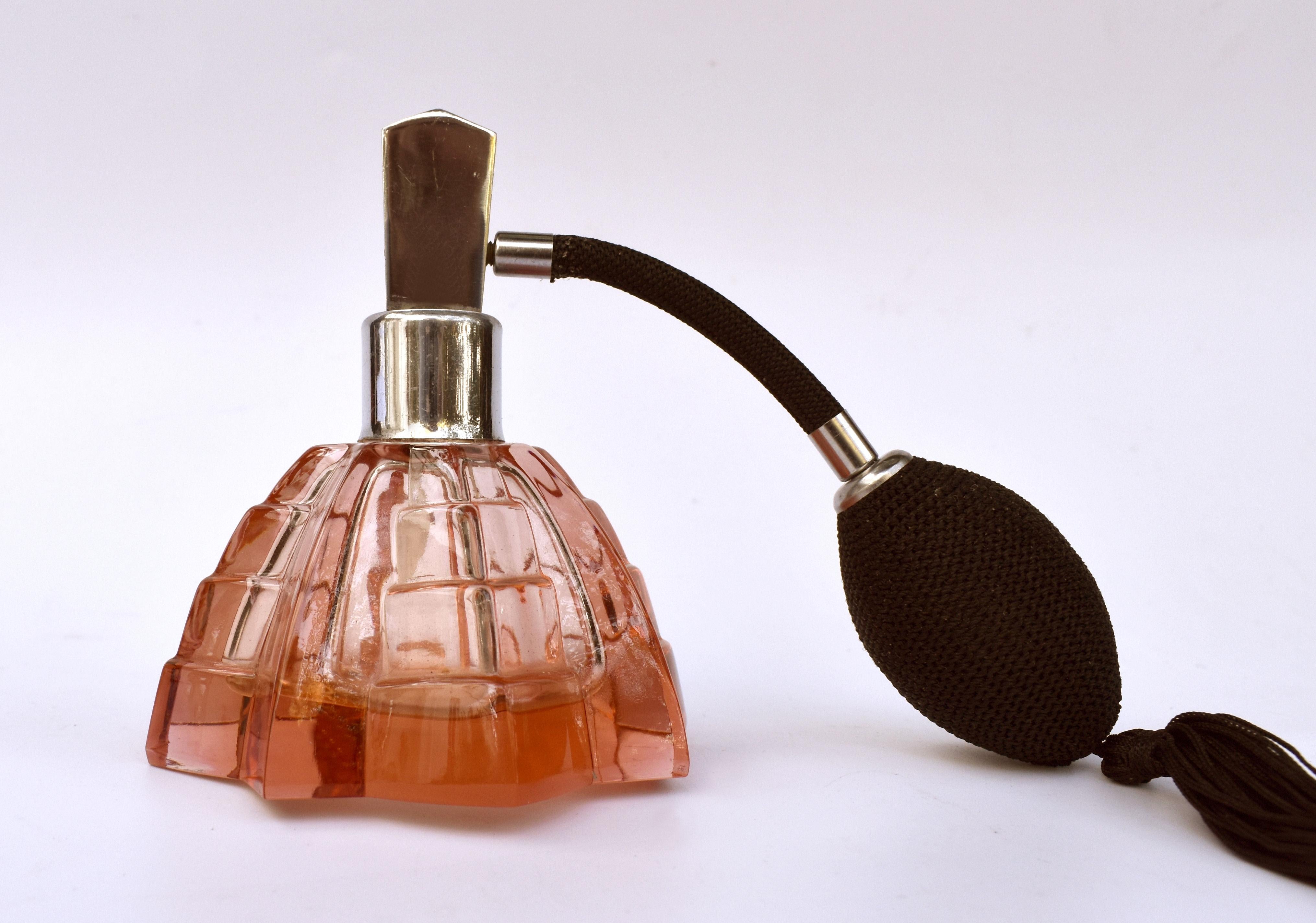 This fabulous Art Deco atomiser is an absolute delight. Cut glass body with multi angled edges is in a beautiful pink colour with black silk bulb and tassel. It will look superb on a dressing table or bathroom shelf. Good vintage condition, dating