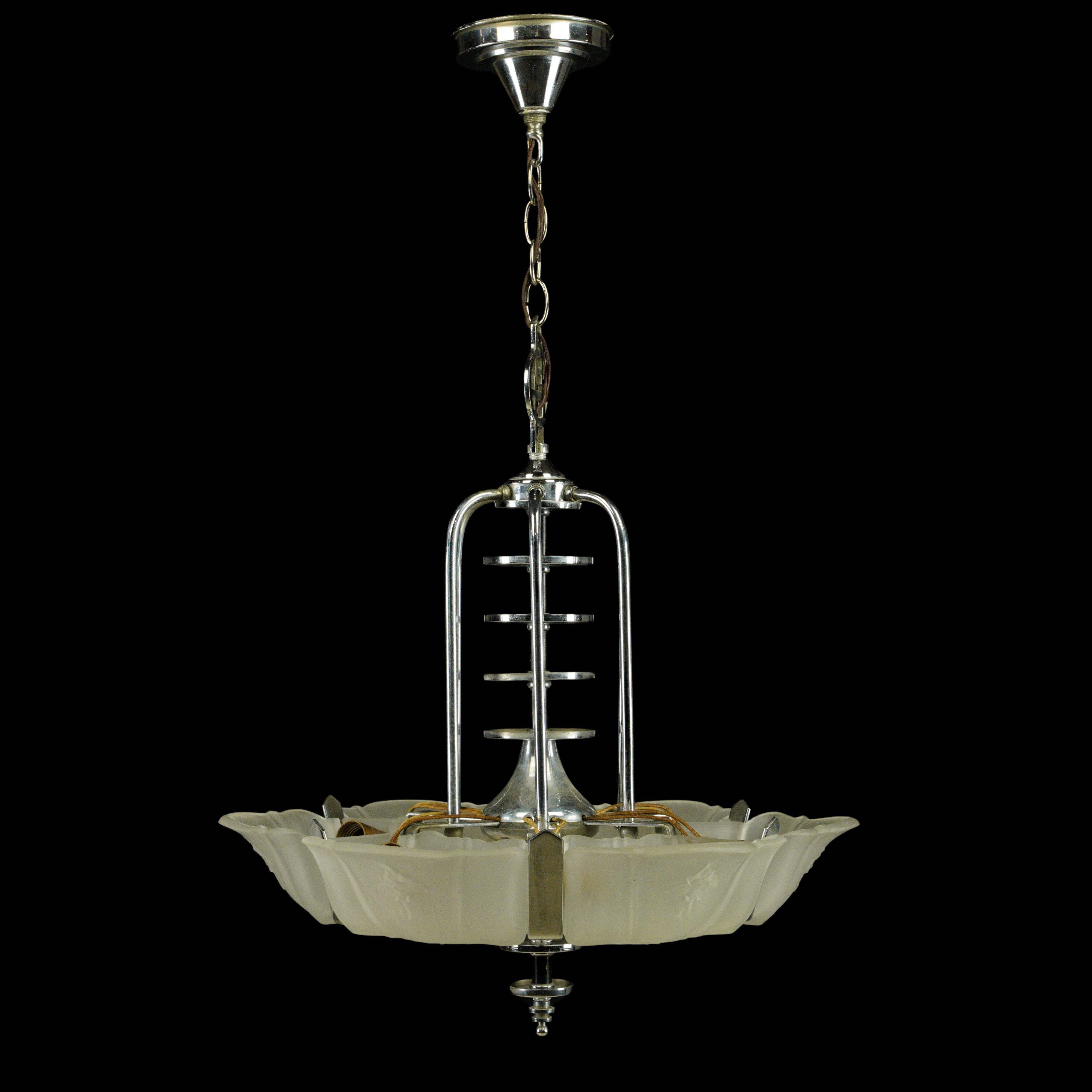 Art Deco steel hardware chandelier with six translucent glass slip shades. This requires six standard medium base bulbs. Good condition with appropriate wear from age, with minor scratches. One available. Cleaned and restored. Please note, this item