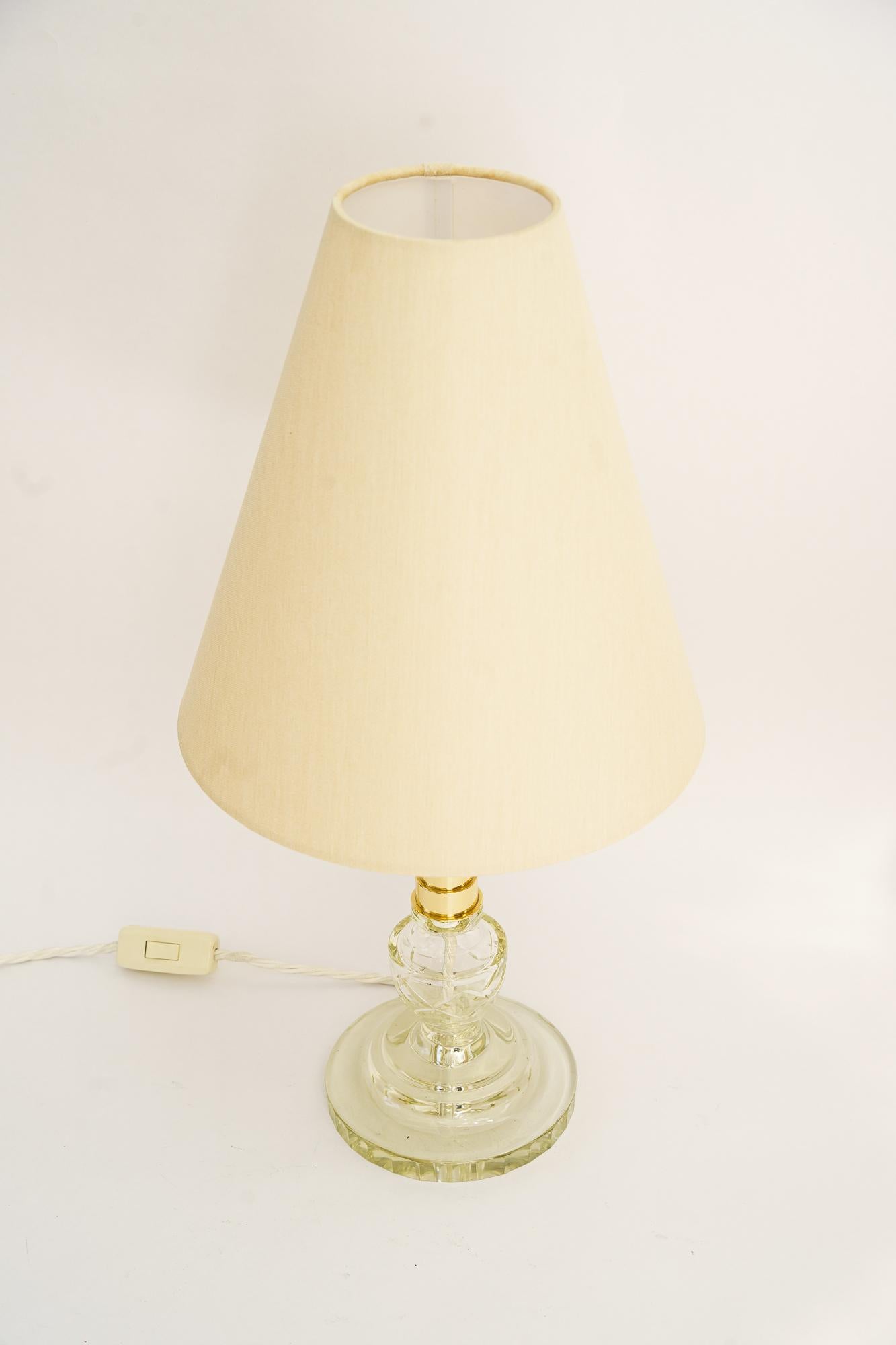 Art Deco Glass table lamp with fabric shade around 1920s 
Brass polished and stove enameled
The Fabric shade is replaced ( new )