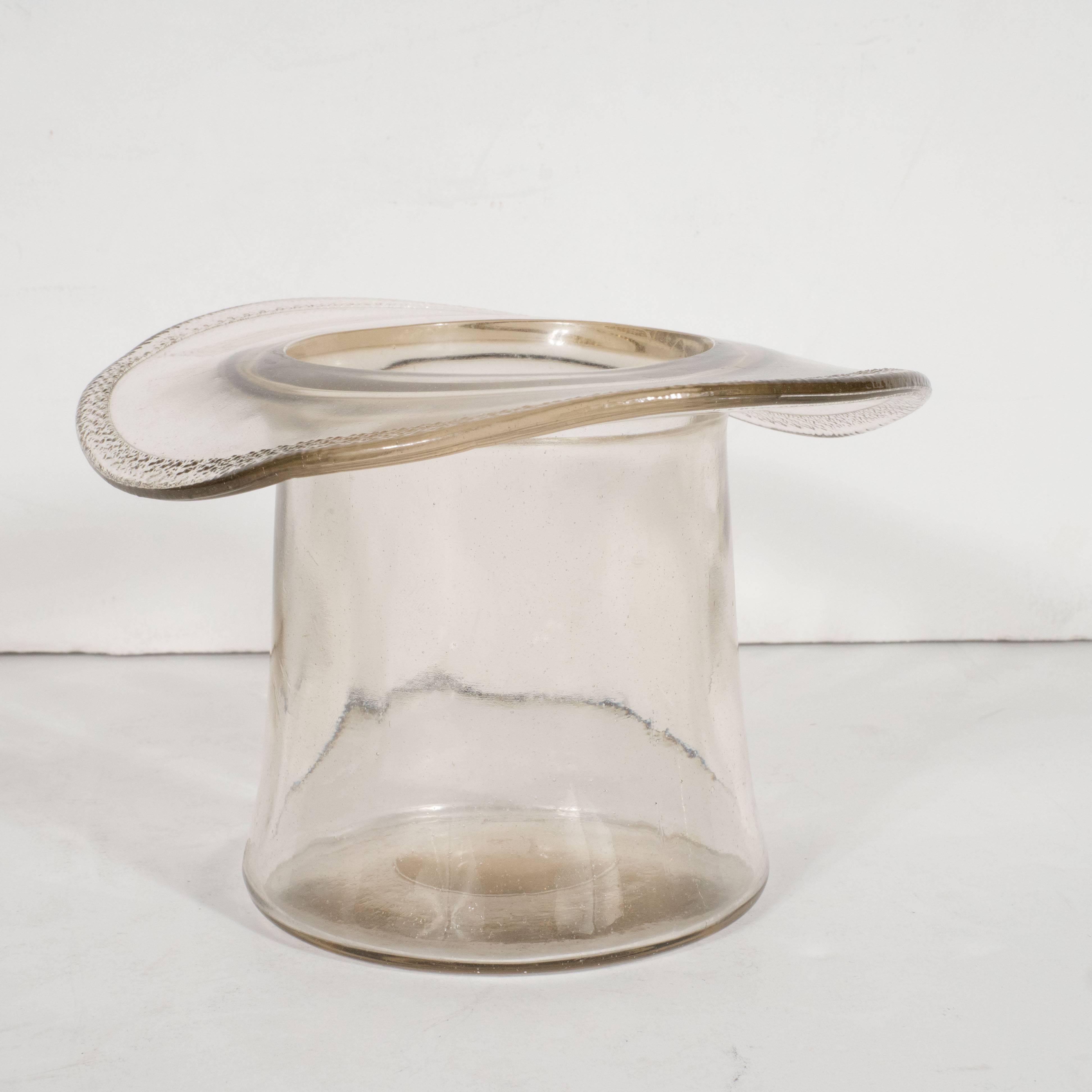 This 1940s Art Deco ice bucket, in the shape of a top hat, features elegant curves and a textured edge circumscribing the brim. This would be an ideal vessel to present a Fine bottle of wine for a black tie dinner party or to add an air of