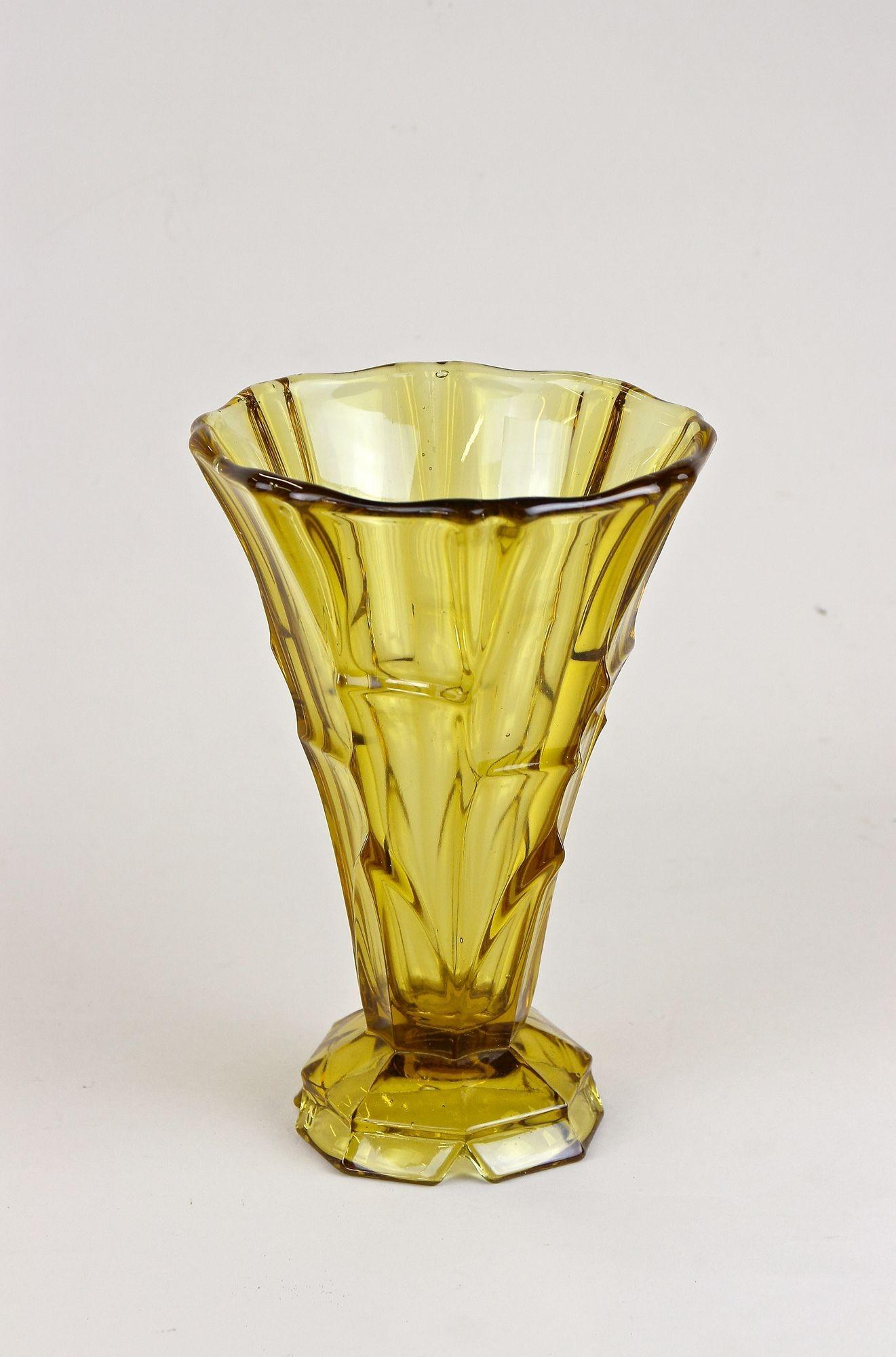 Lovely 20th century amber colored glass vase from the early Art Deco period in Austria around 1920. A fantastic shaped glass vase adorned by a special design building beautiful pattern depending on the incidence of light. This beautifully looking