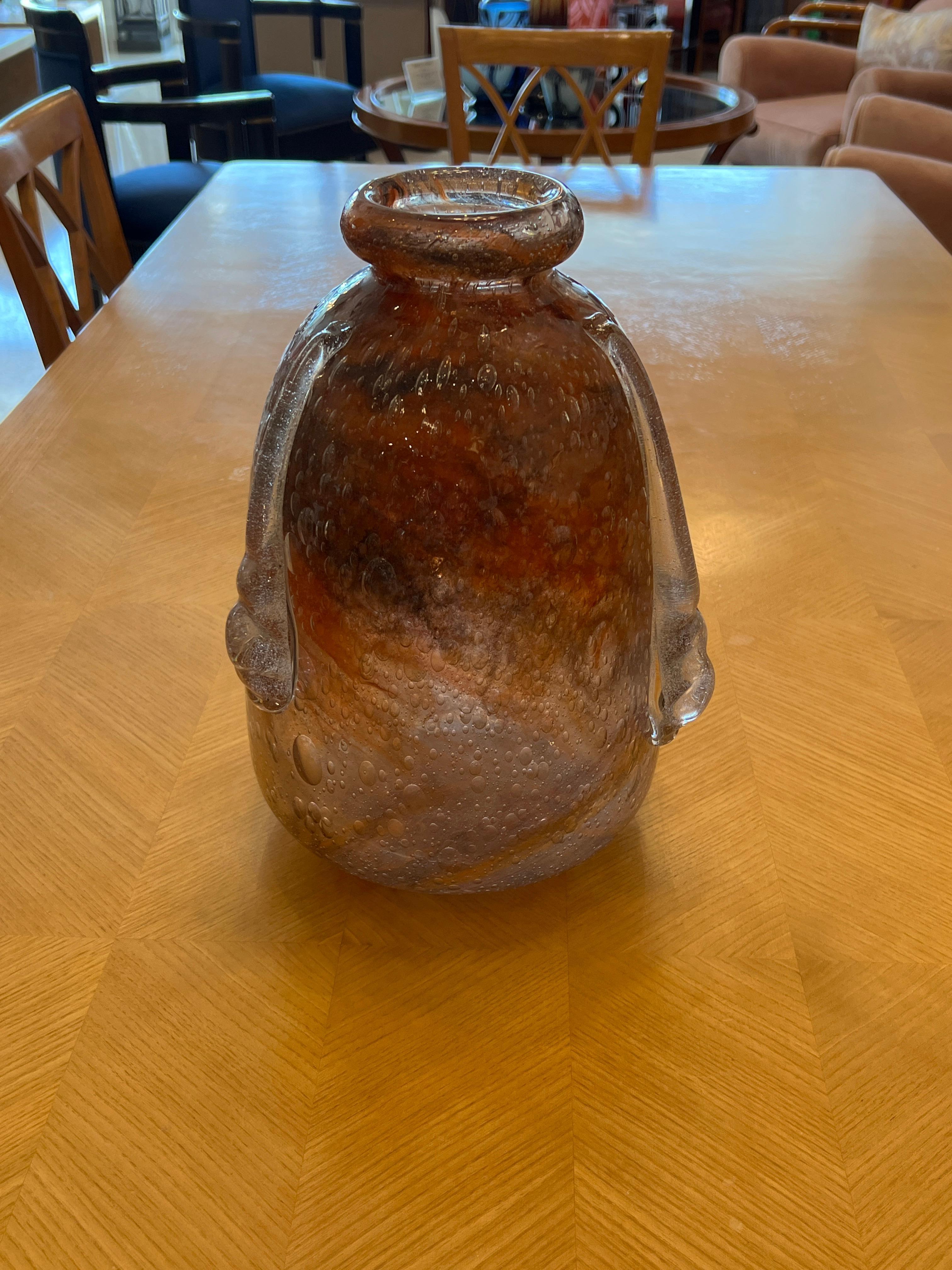 A Blown Glass Vase in hues of Burnt Orange with drops of clear glass details.  This vase is signed By Charles Schneider
Charles Schneider was a renowned glassmaker during the Art Deco period in France. He was known for his beautiful and intricate