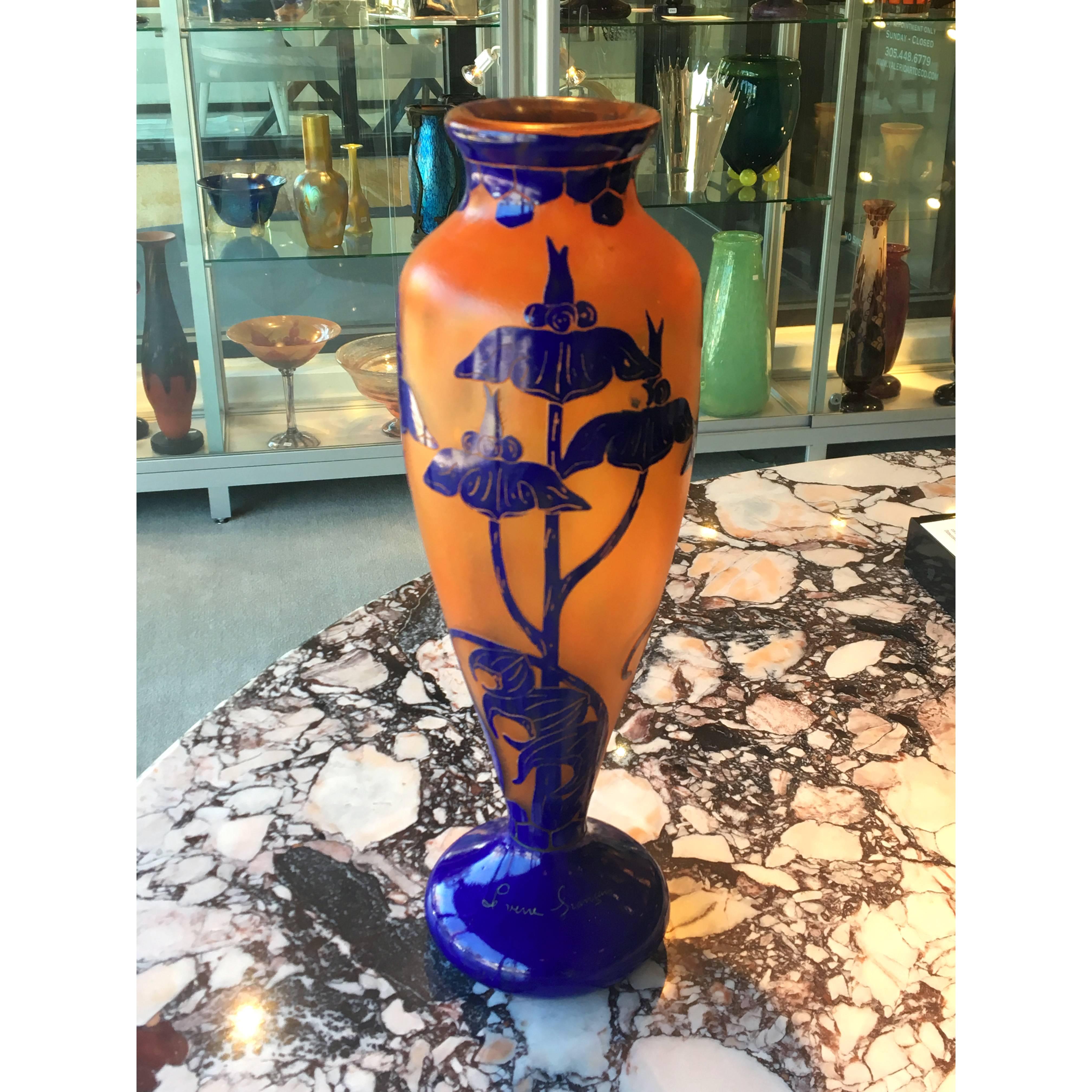 Art Deco cameo glass vase, overlaid with deep cobalt blue color and orange background, etched and wheel carved depicting the Solannée pattern designed by Le Verre Francais studio, under the direction of Charles Schneider.
Made in France 
circa