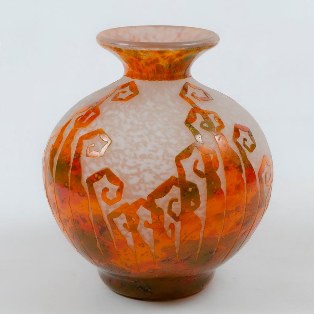 French art deco cameo glass vase was created by Charles Schneider (1881 – 1953). The vase, in the “Fougeres” cutting depicts geometric ferns in mottled orange, red and green glass over a mottle white underlayer.
Perfect condition.