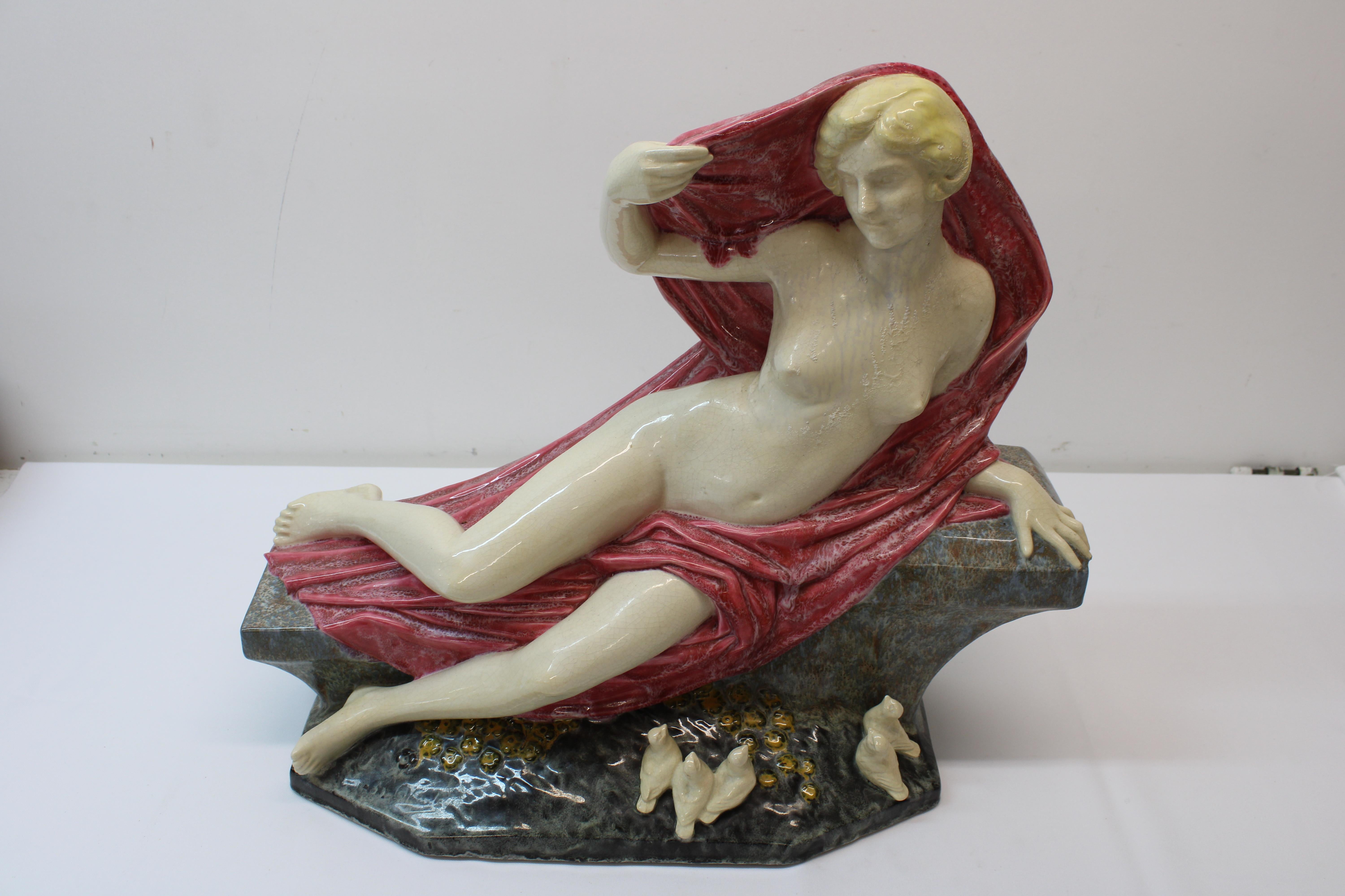 This Magnificent Female nude sculpture holds no bounds, Calmly sitting with birds while slightly covering herself she is a true beauty. Done in the 1930's she sits quietly & serene waiting to be displayed in any household.