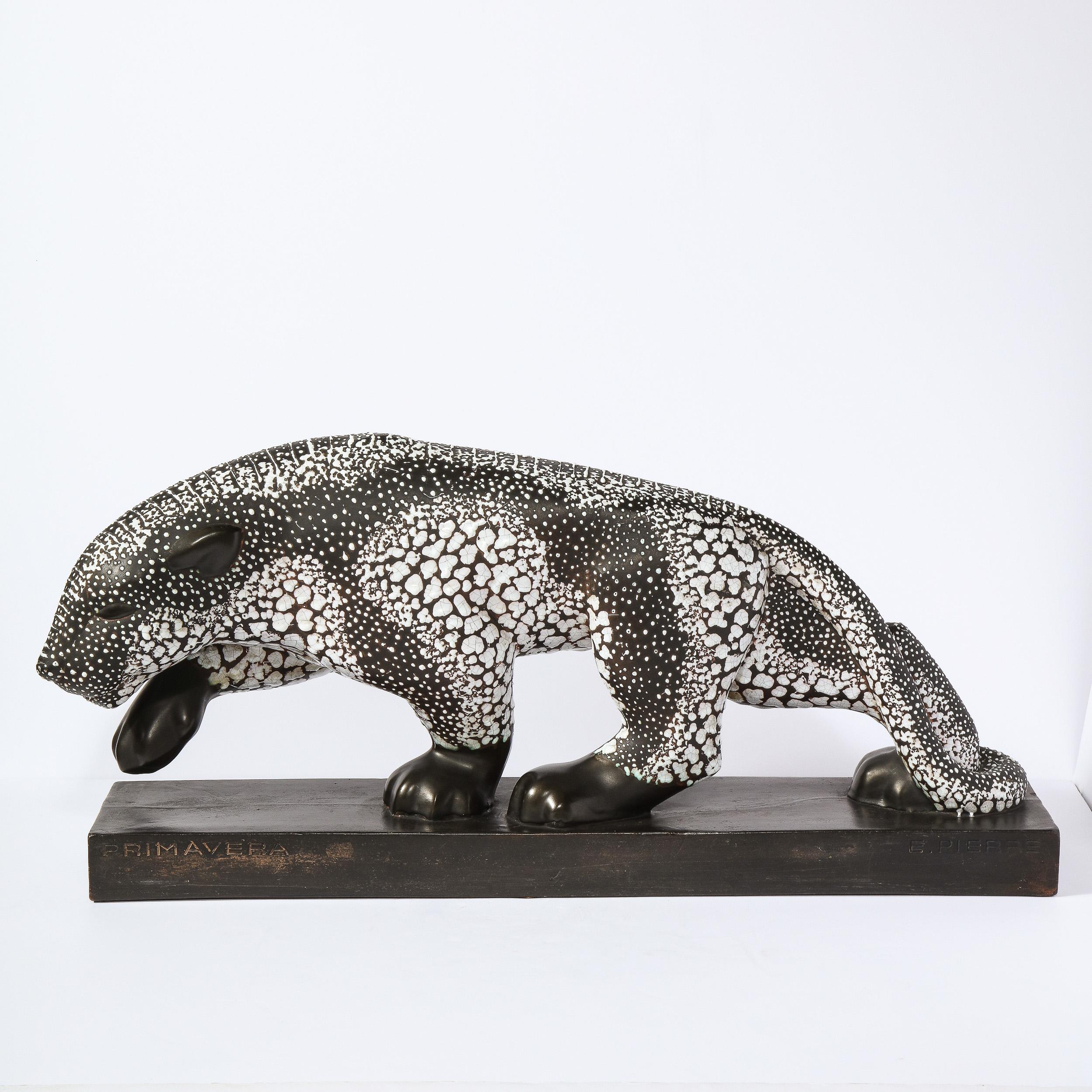 This refined and important Art Deco stylized ceramic Panther sculpture was realized in France for Atelier Primavera au Printemps, circa 1920. It offers an elegantly striding earthenware black panther with a white mottled glaze with one foot