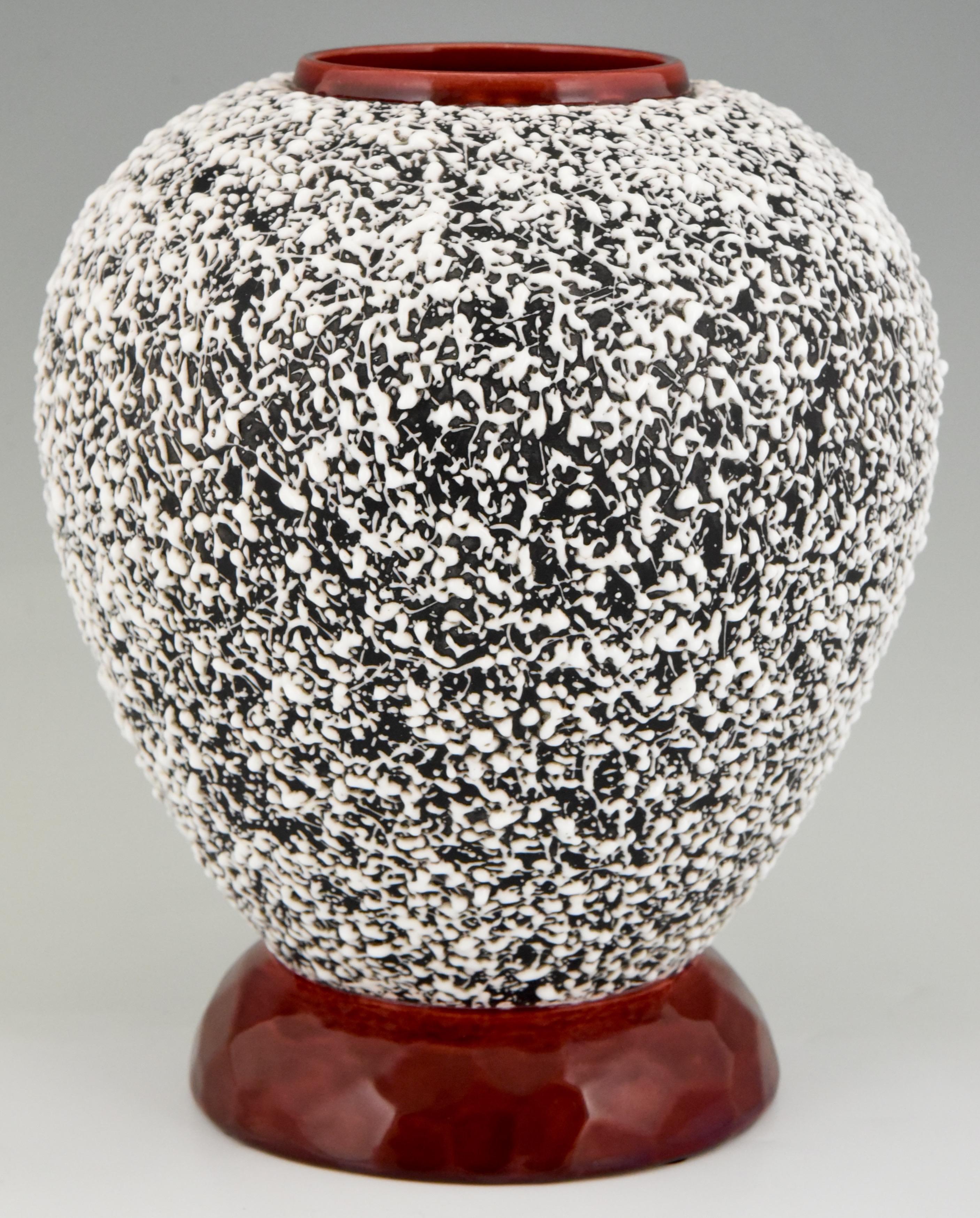 Art Deco globular ceramic vase anthracite grey surface with white textured glaze, oxblood rim and foot. 
Design by Paul Milet for Sèvres, France, 1930.

Literature:
“The Encyclopedia of Decorative Arts 1890-1940” by Philippe Garner. ?“Art Deco
