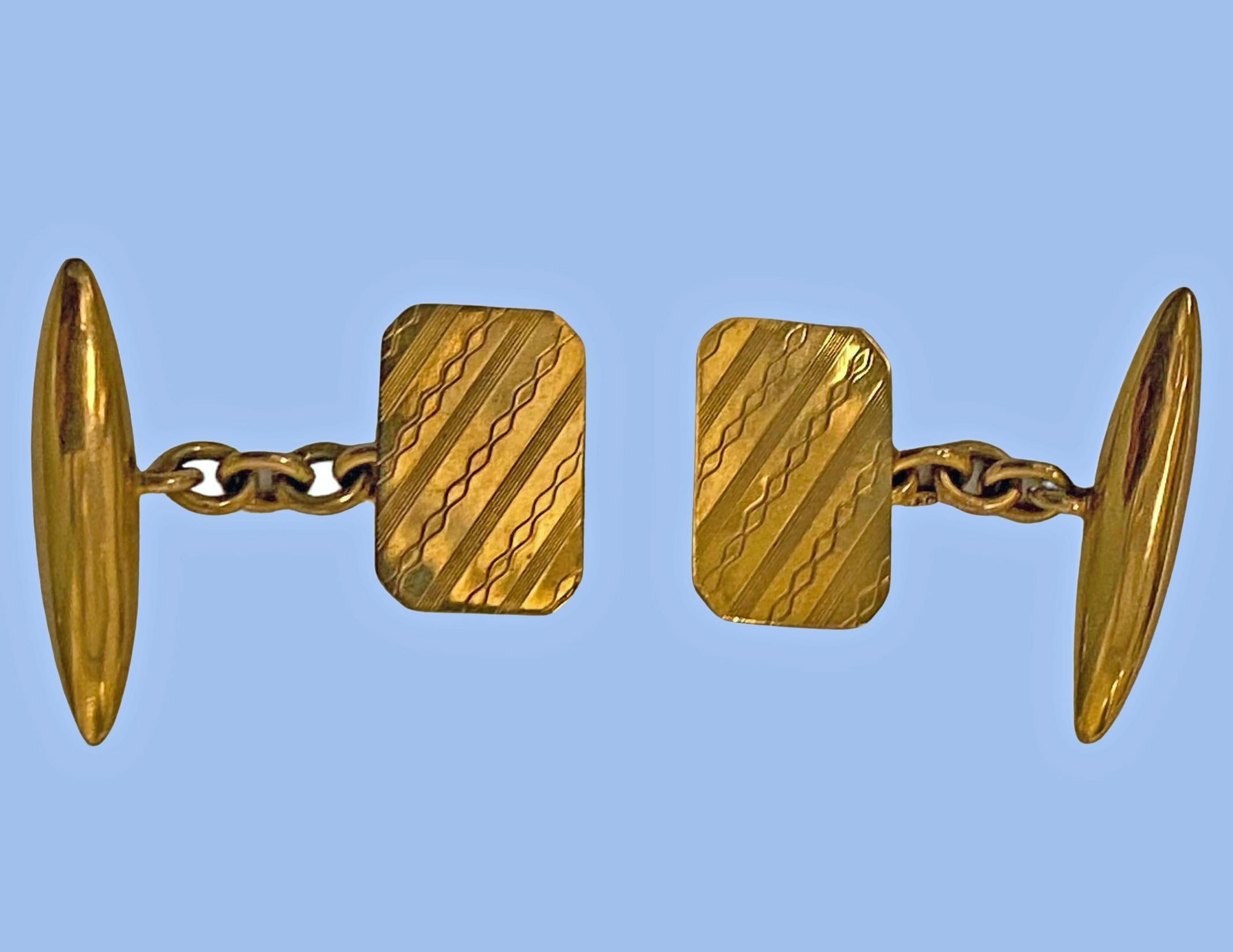 Art Deco Gold Cufflinks Birmingham 1928. The fully hallmarked 9ct cufflinks with striking alternating diagonal wriggle work and groove sectional design, the reverse with plain torpedo fitments, gold chain link between. Fronts measure: 15.70 x 10.03