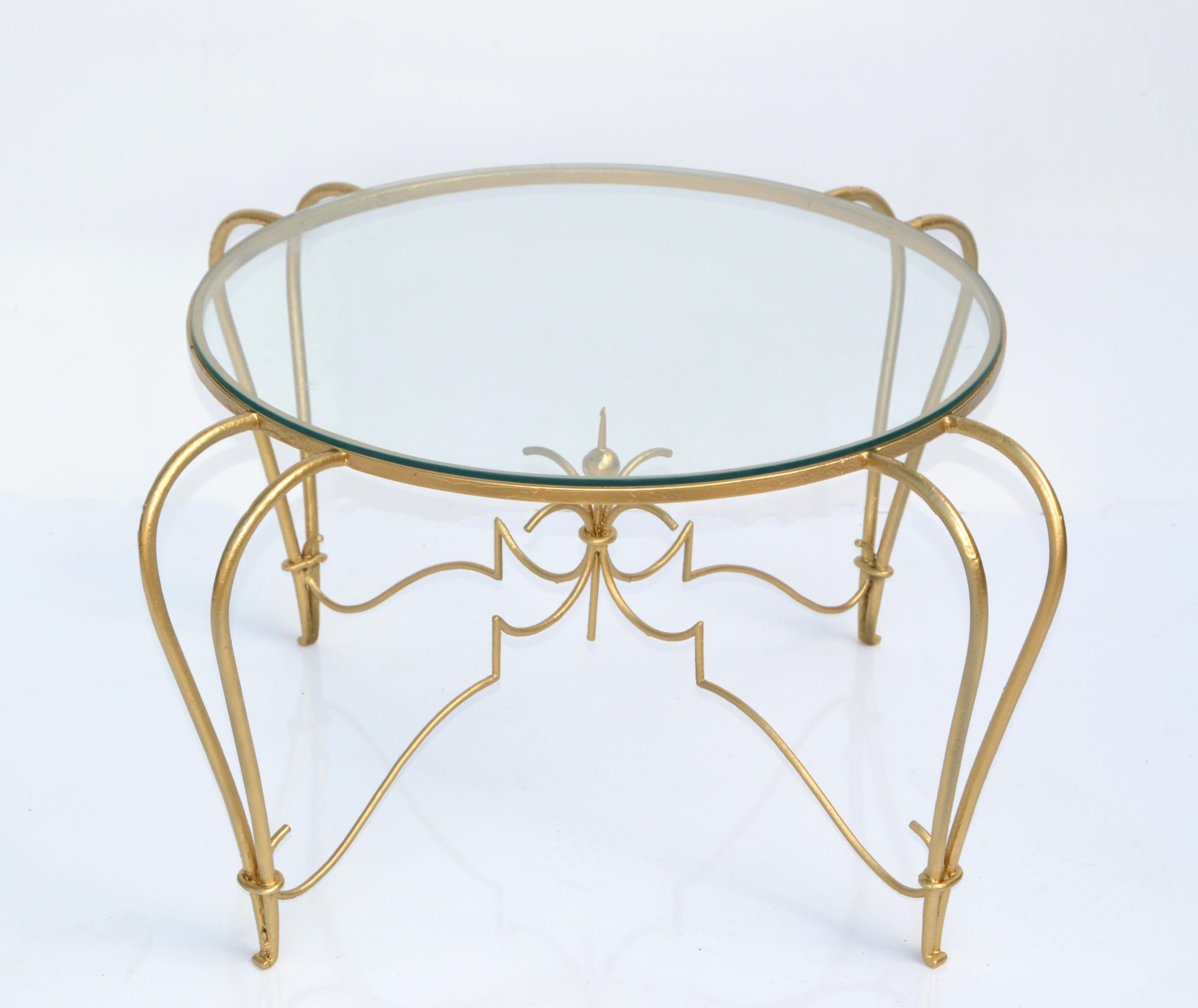 Superb Art Deco gold finish round wrought iron coffee or cocktail table with round glass top, made in France 1950.
Round glass measures: 24 inches Diameter & 0.25 inches thick.
Very good condition with some scuffs to the gold finish due to use and