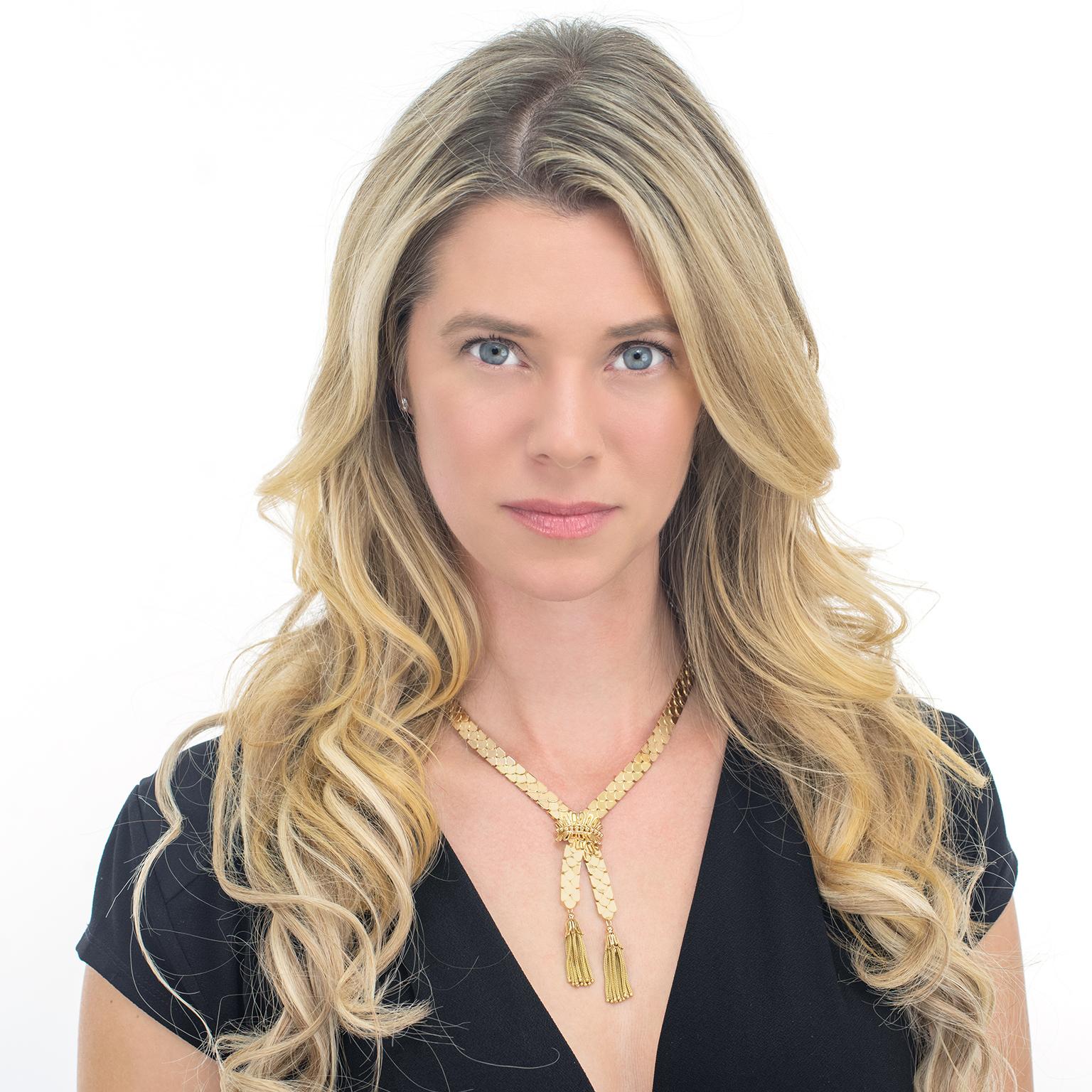 Circa 1930s, 18k, Switzerland.   This sophisticated 18k gold accessory puts a sumptuous Deco spin on the classic lariat. The iconic scalloped motif necklace is decoratively clasped at the cross over and hung with capped gold tassels. Heavy and ropey