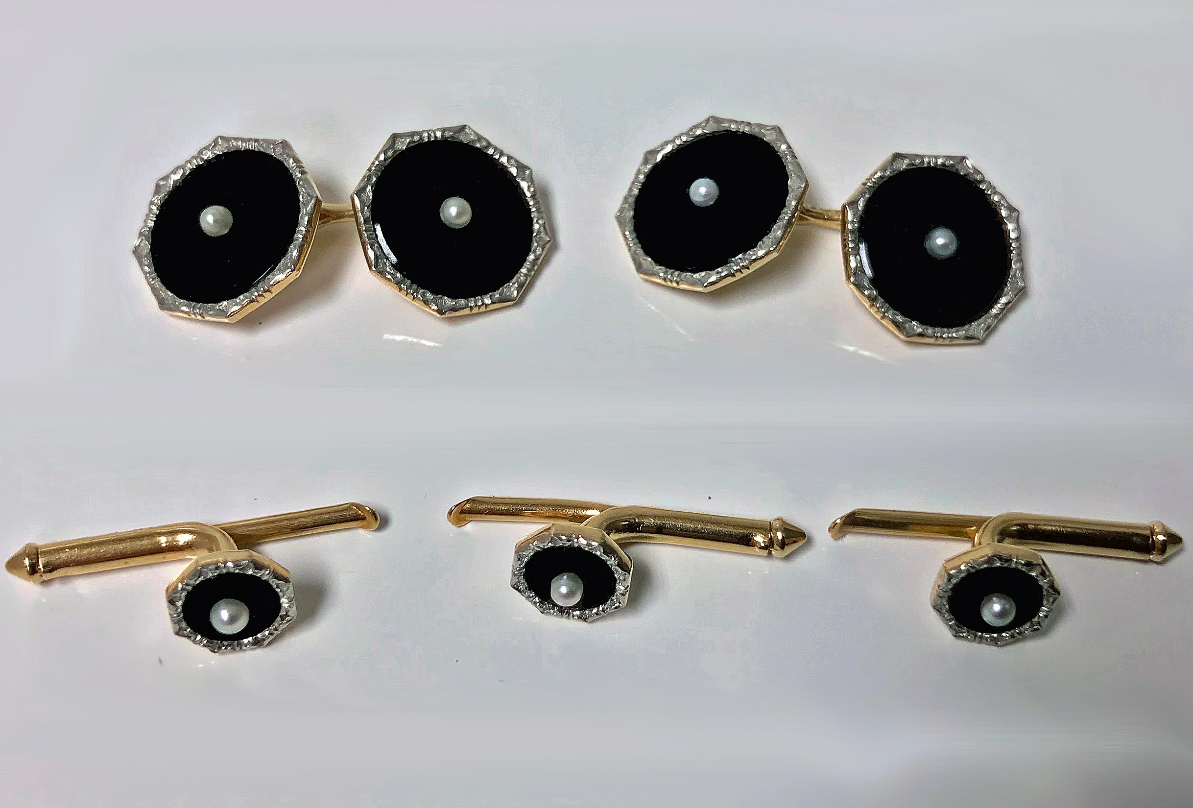 14K Gold, black Onyx and Pearl Cufflink and Stud set.  Each octagonal shaped circular piece centering a small natural Pearl on black onyx, the borders of chased white gold; comprising pair of Cufflinks and three studs with gold slide spring