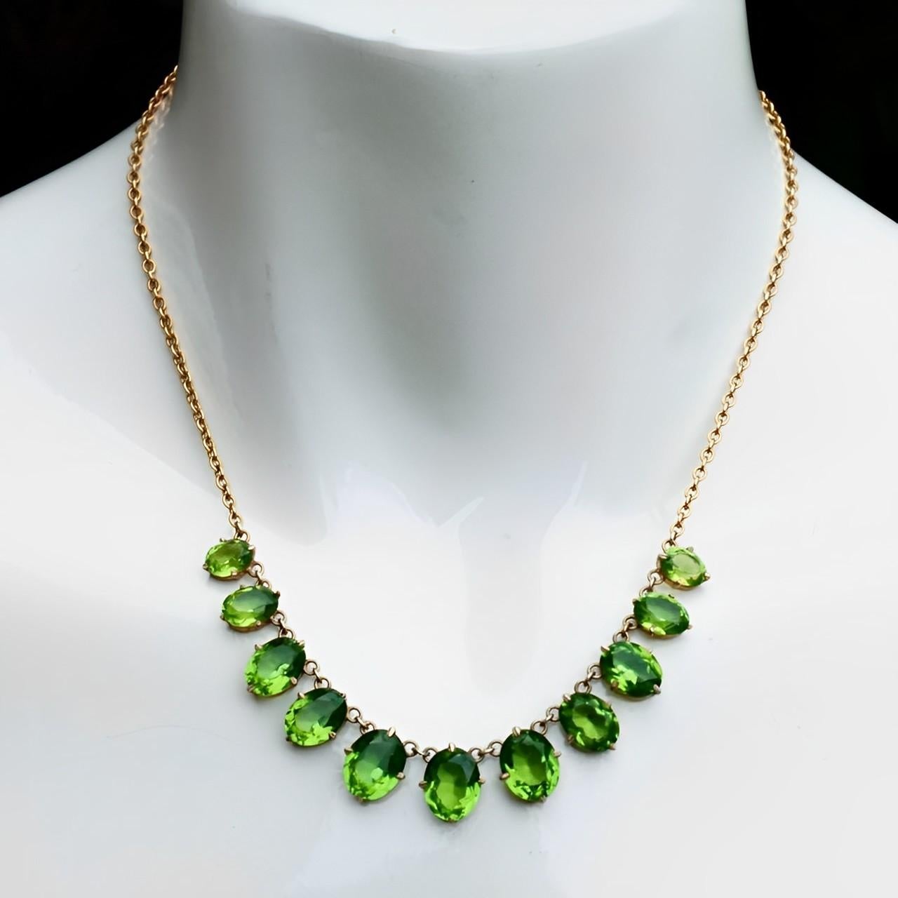 Beautiful Art Deco gold plated necklace, featuring eleven graduated apple green paste stone drops in open back settings. The faceted paste stones are raised at the front and pointed at the back, for maximum sparkle. Length 42.7  / 16.8 inches and