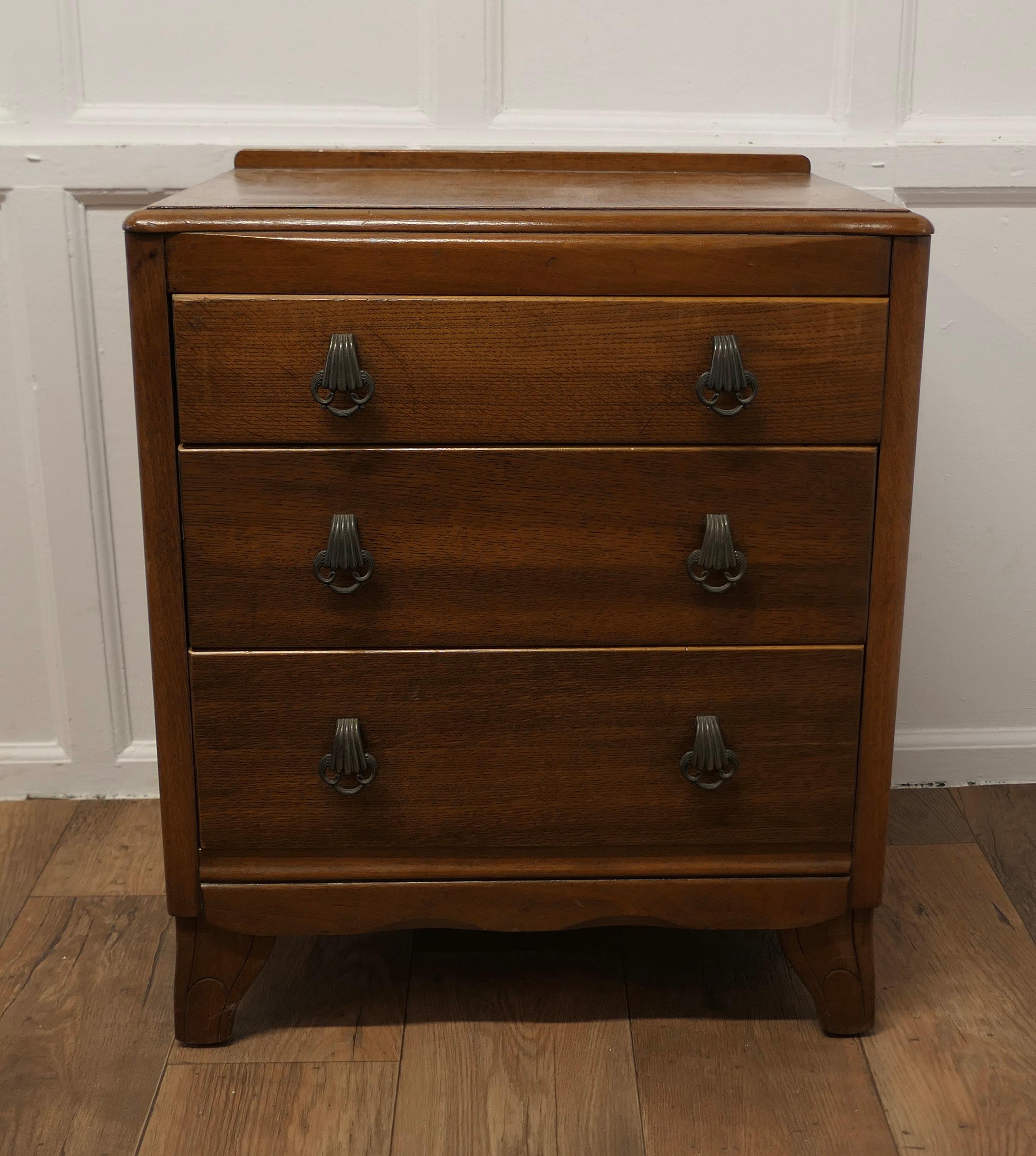Art Deco Golden Oak Chest of Drawers by Lebus

This is a Classic piece of Oak Furniture from the 1930/40 Art Deco period, the chest has a slight curve to the top with a moulded edge 
The 3 long drawers have sturdy decorative handles and it stands