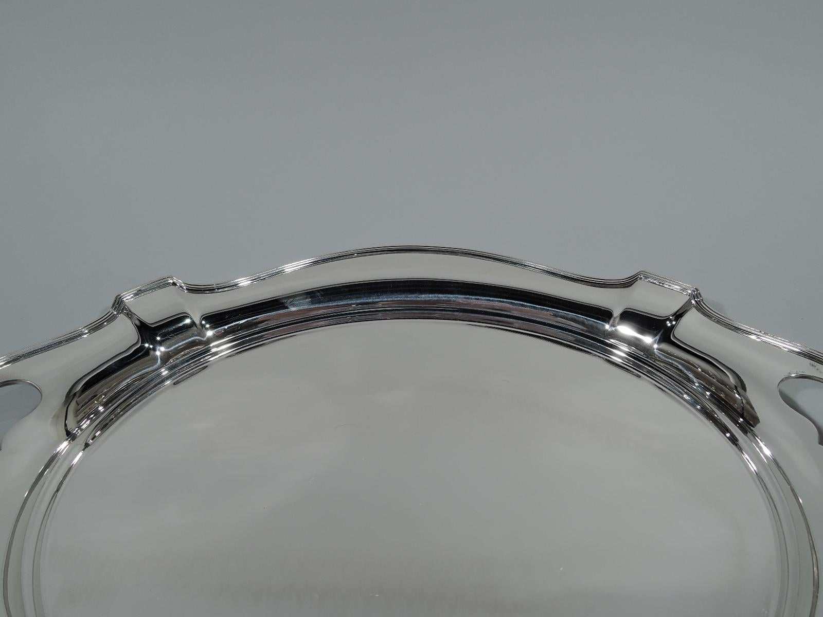 Art Deco sterling silver serving tray in Plymouth pattern. Made by Gorham in Providence in 1919. Oval well and reeded and paneled rim with cutout kidney end handles. Hallmark includes no. A2787 and date symbol. Weight: 26.7 troy ounces.
