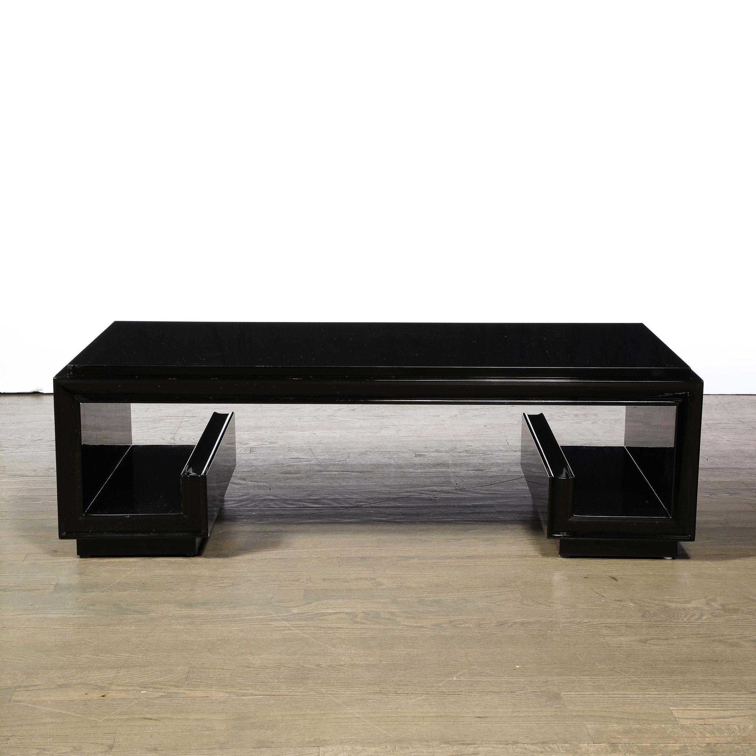 This refined and graphic cocktail table was realized by the great Paul Frankl in the United States circa 1947. It features a stylized and abstracted Greek Key motif in black lacquer. The table suggests a three sided rectangle with an open bottom,