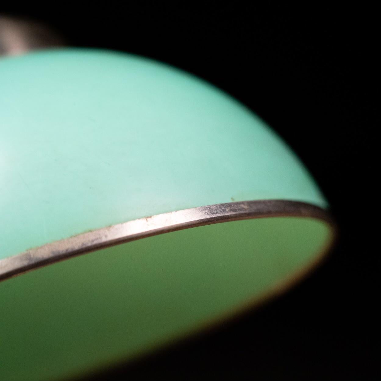 Art Deco green Bakelite desk lamp. This Bauhaus style desk lamp dates from the late 1920s and was made in Germany. 
Features nickel plated brass with a green Bakelite shade and green Bakelite details on the base. The shade can be put in different