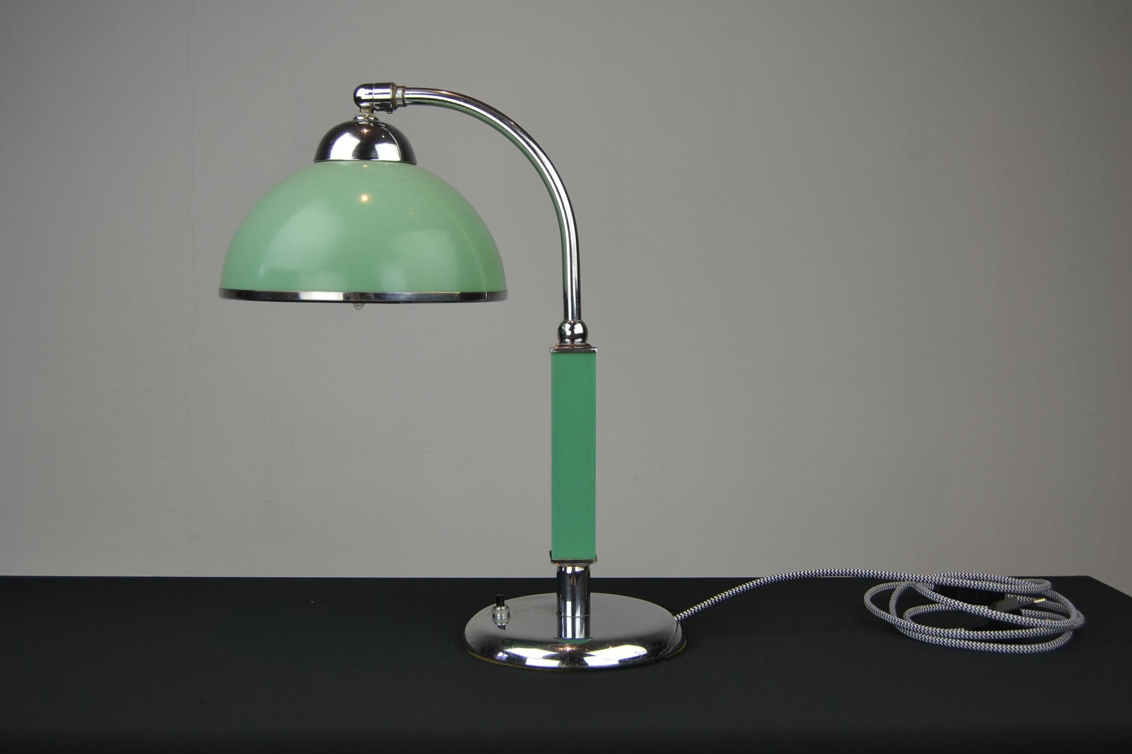 Art Deco green Bakelite desk lamp.
This Bauhaus style desk lamp dates from the late 1920s and was made in Germany. It's made from nickel plated brass with a green Bakelite shade and green Bakelite details on the base. 

The shade can be put in