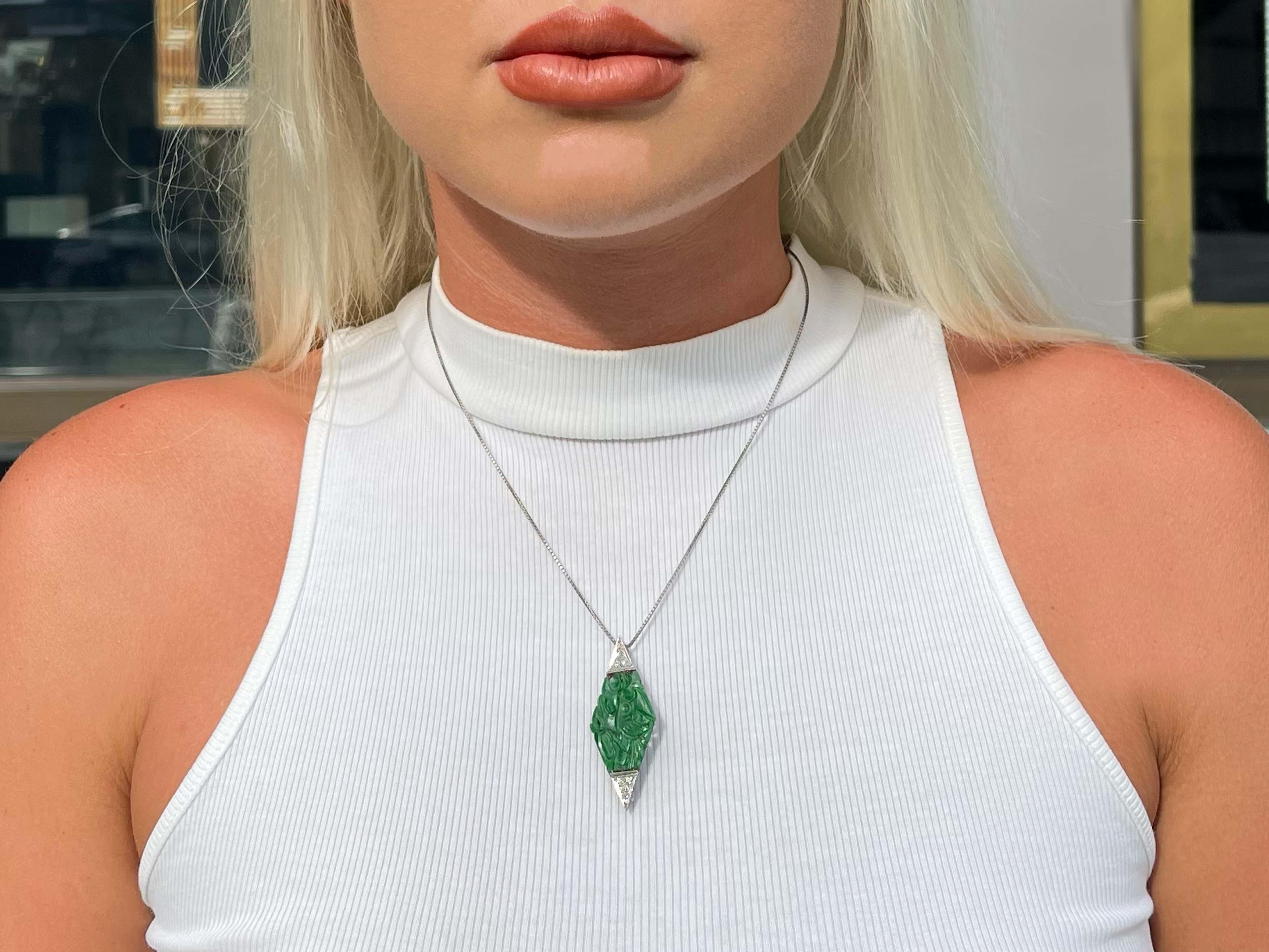 Art Deco Green Carved Jadeite Jade and Diamond Pendant Brooch in Platinum. Gorgeous hand crafted art deco brooch with a carved pierced apple green jade of a bird on a branch design. The brooch is bead set with 8 old European cut diamonds, 4 on each