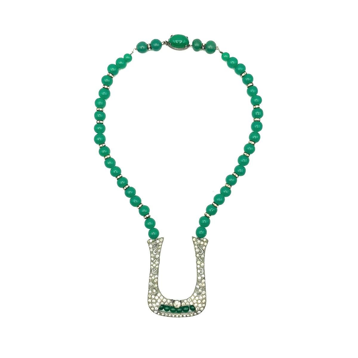 A beautiful and rare Art Deco Green Chalcedony Glass & Paste sautoir necklace dating to the 1920s. Crafted with green glass beads emulating green chalcedony, paste rondelles and paste chatons in a pot metal setting. Very good vintage condition,