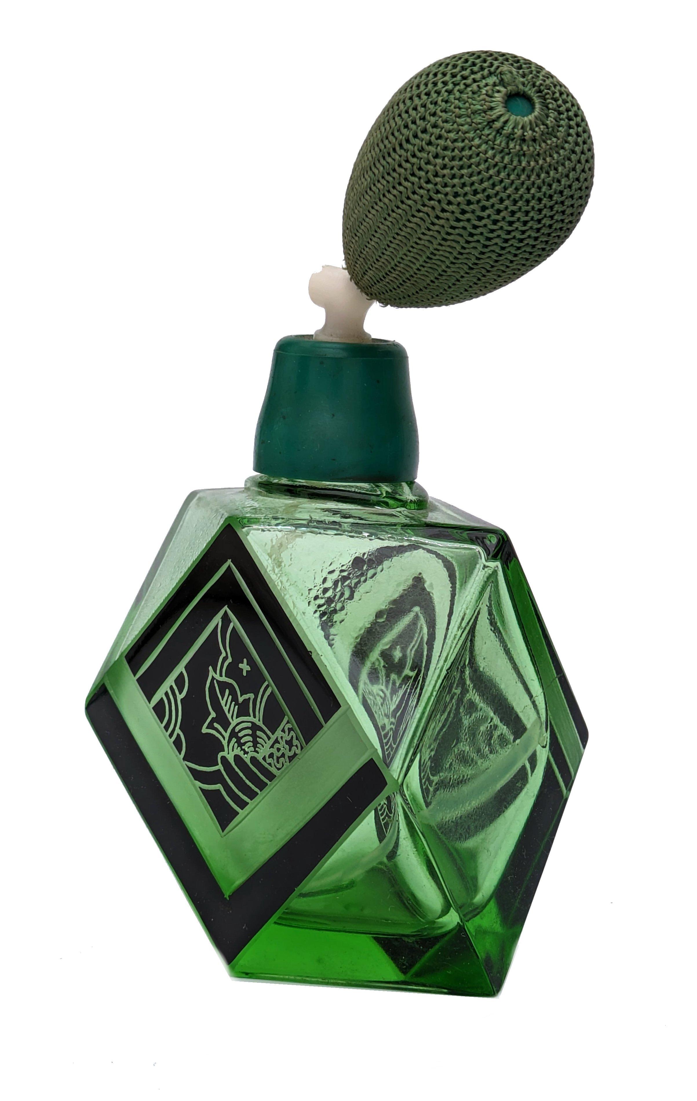Impresionante frasco de perfume Art Decó de vidrio verde con decoración geométrica de esmalte negro y original soplador de seda. Precioso cristal verde intenso, muy coleccionable que data de la década de 1930. De origen checo. Magnífico diseño