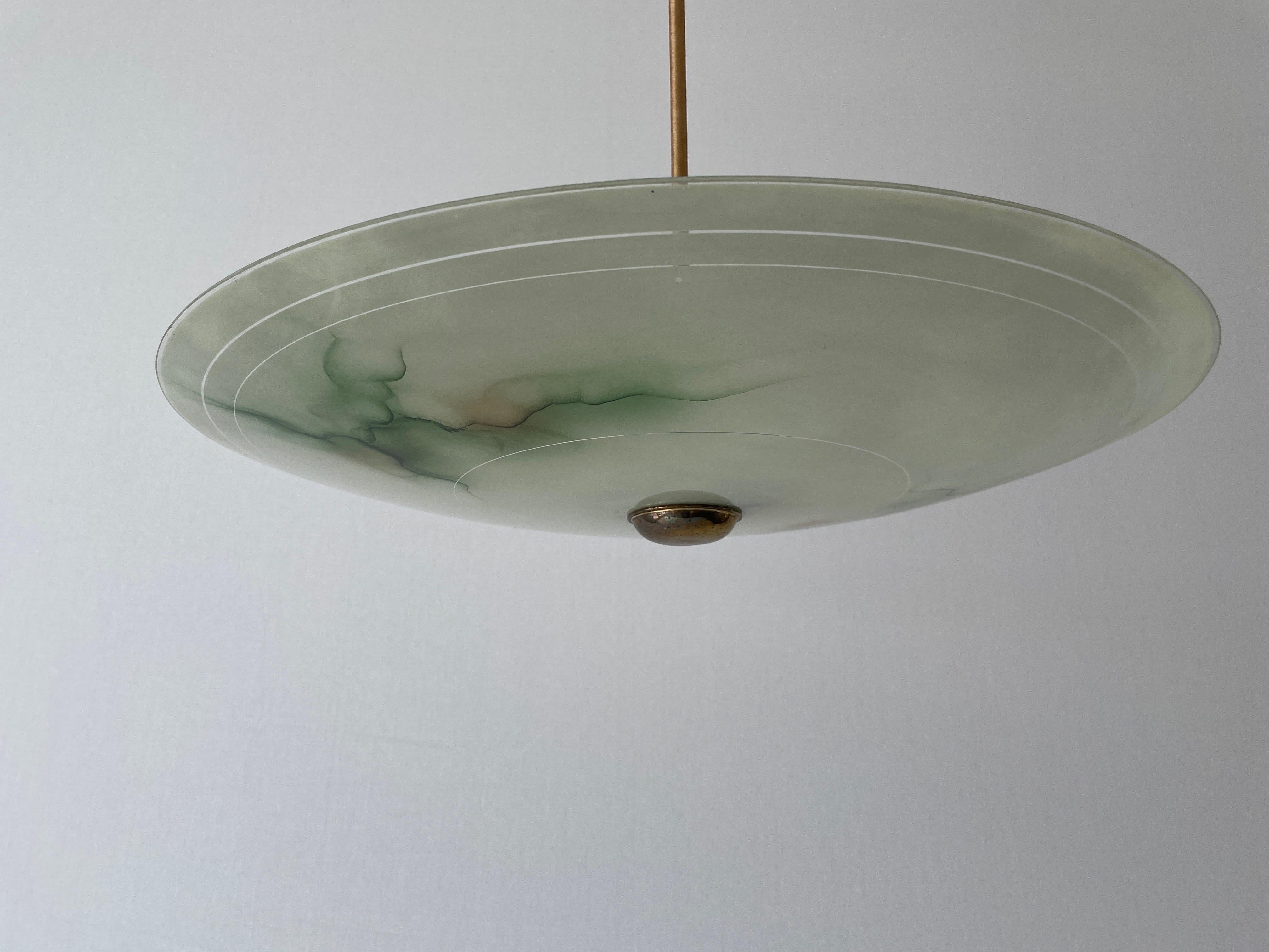 Art Deco Green Glass Ceiling Lamp, 1940s, Germany

This lamp works with 2x E27 light bulbs.

Measurements: 
Height: 50 cm
Shade diameter and height: 55 cm and 8 cm


