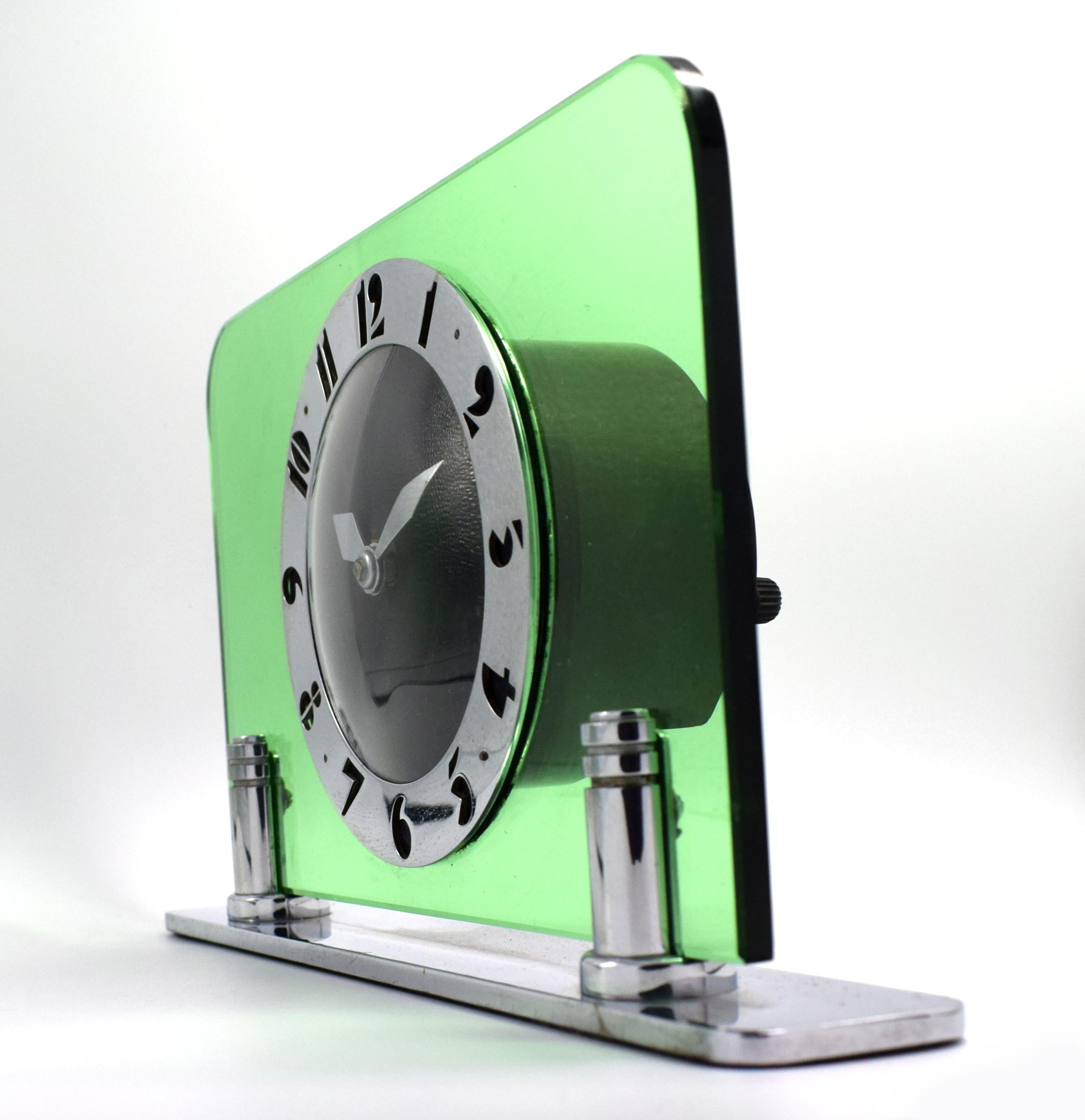 Original 1930s green glass and chrome clock by the English clock makers Smiths. Beautiful green body with black dial face and fretted chrome stylised deco numerals. Fabulous condition, full working order. (We can provide a power adaptor so the clock