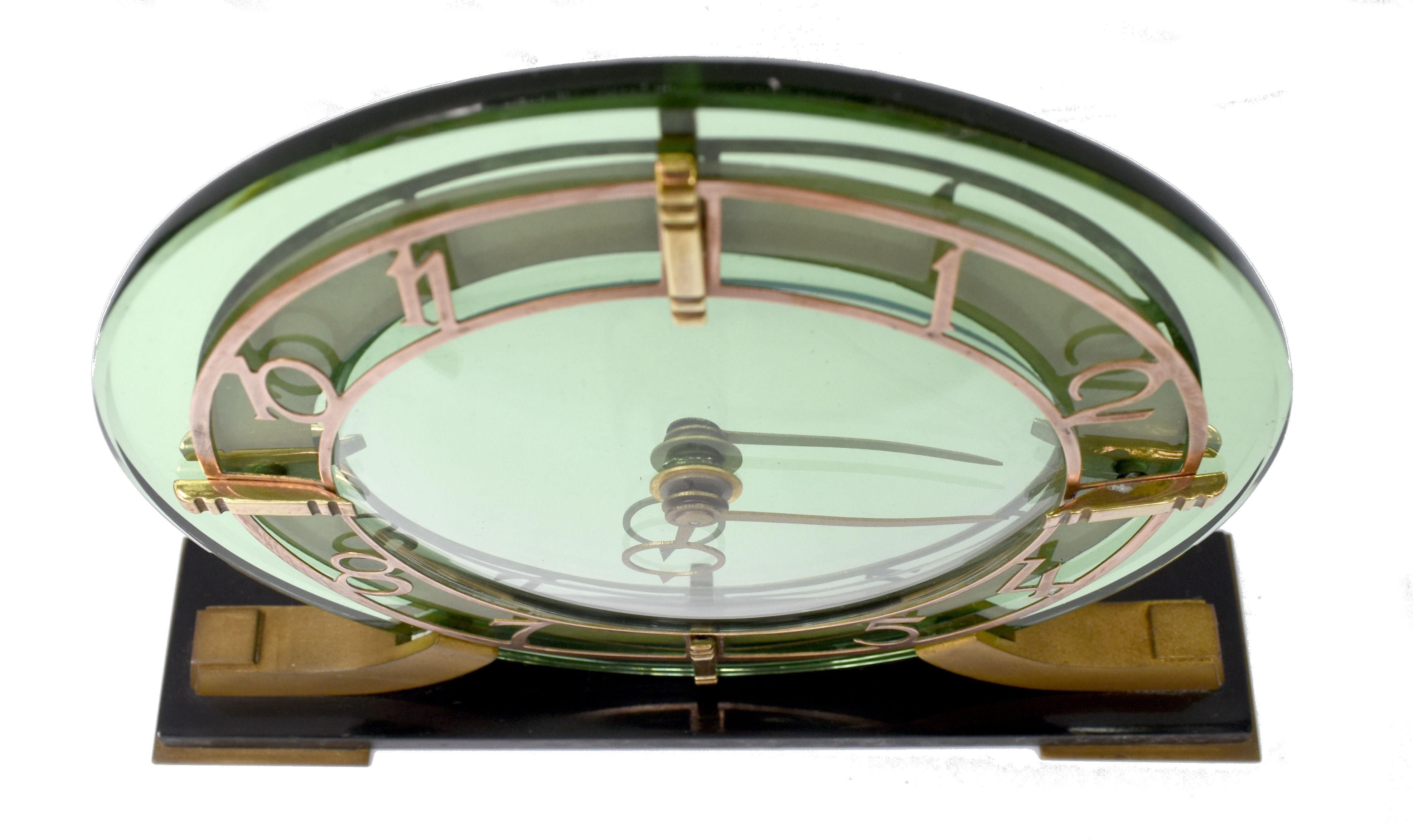 Superb 1930's Art Deco mantel clock by Smiths the British clockmakers . Heavy thick green mirror glass with gold tone stylized Deco numerals all resting on a black vitrolite ( compressed glass) plinth . Beautiful condition throughout, no chips or