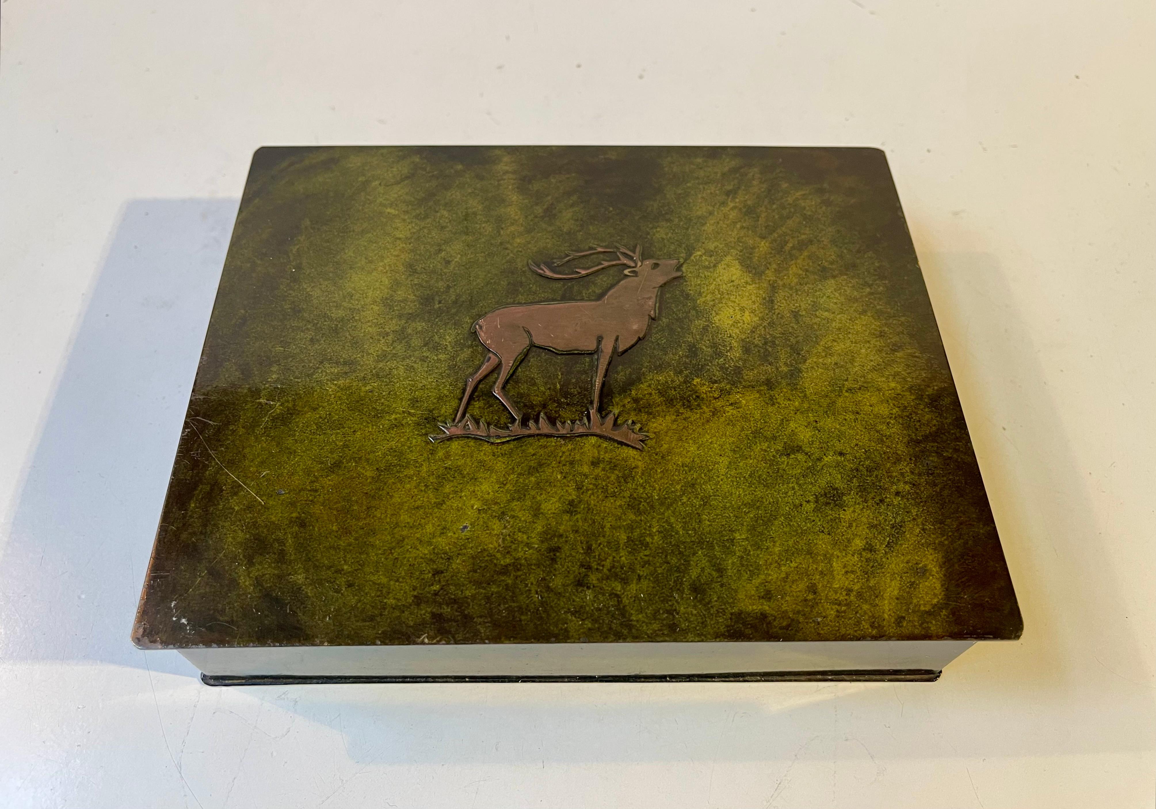 Decorative Bronze box with a green verdigris patina, a relief stag to its lid and wooden interior by Holger Fridericias in Denmark. Made during the 1930s in a style reminiscent of Just Andersen. Suitable for cigarettes, cigars, tea pencils etc. What