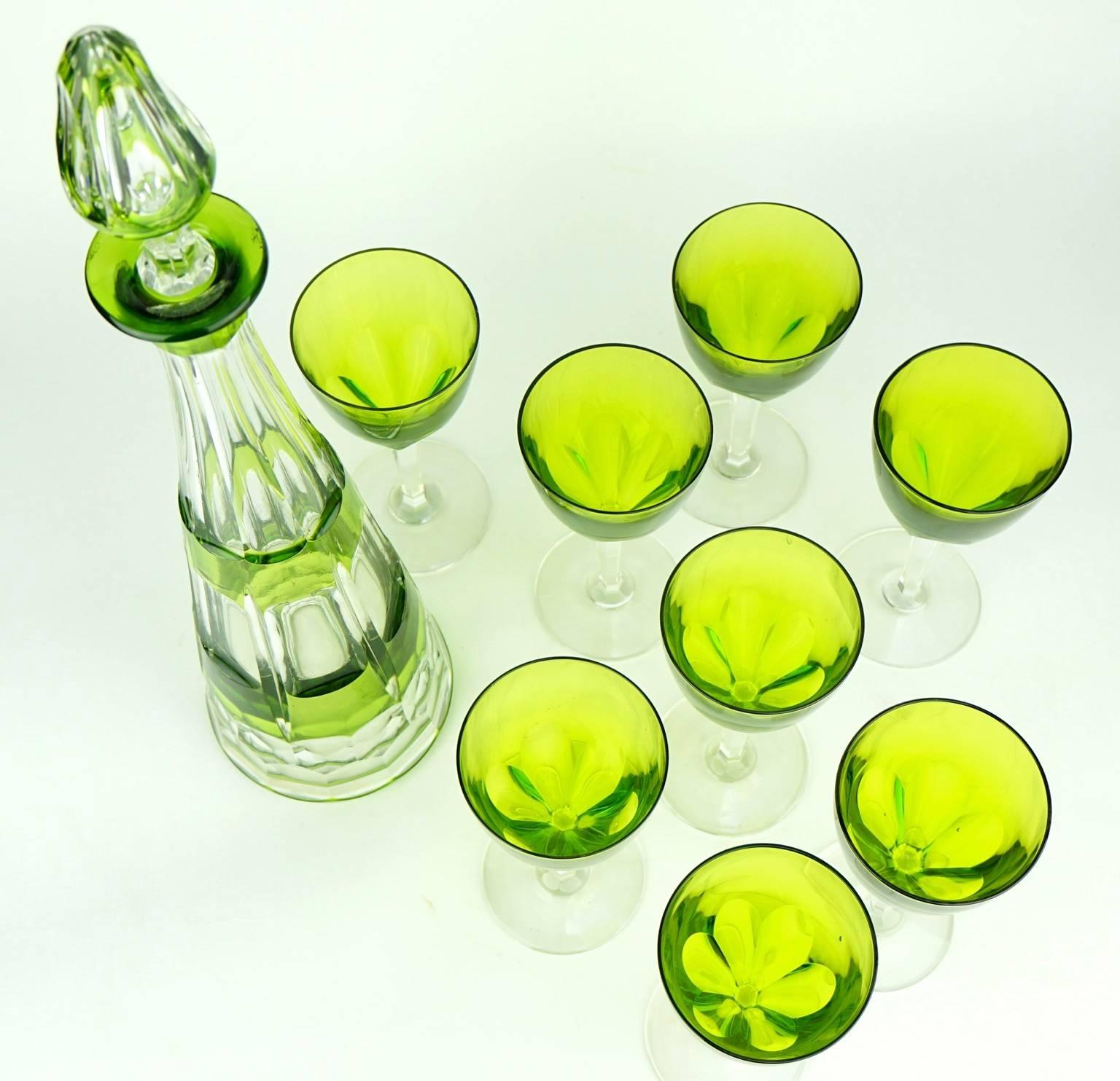 A crystal decanter in vert de Chine green overlay set with eight glasses in very good condition. Original stopper. 
Size:
Decanter, height 42 cm, diameter 10 cm.
Eight glasses, height 15 cm, diameter 7 cm.