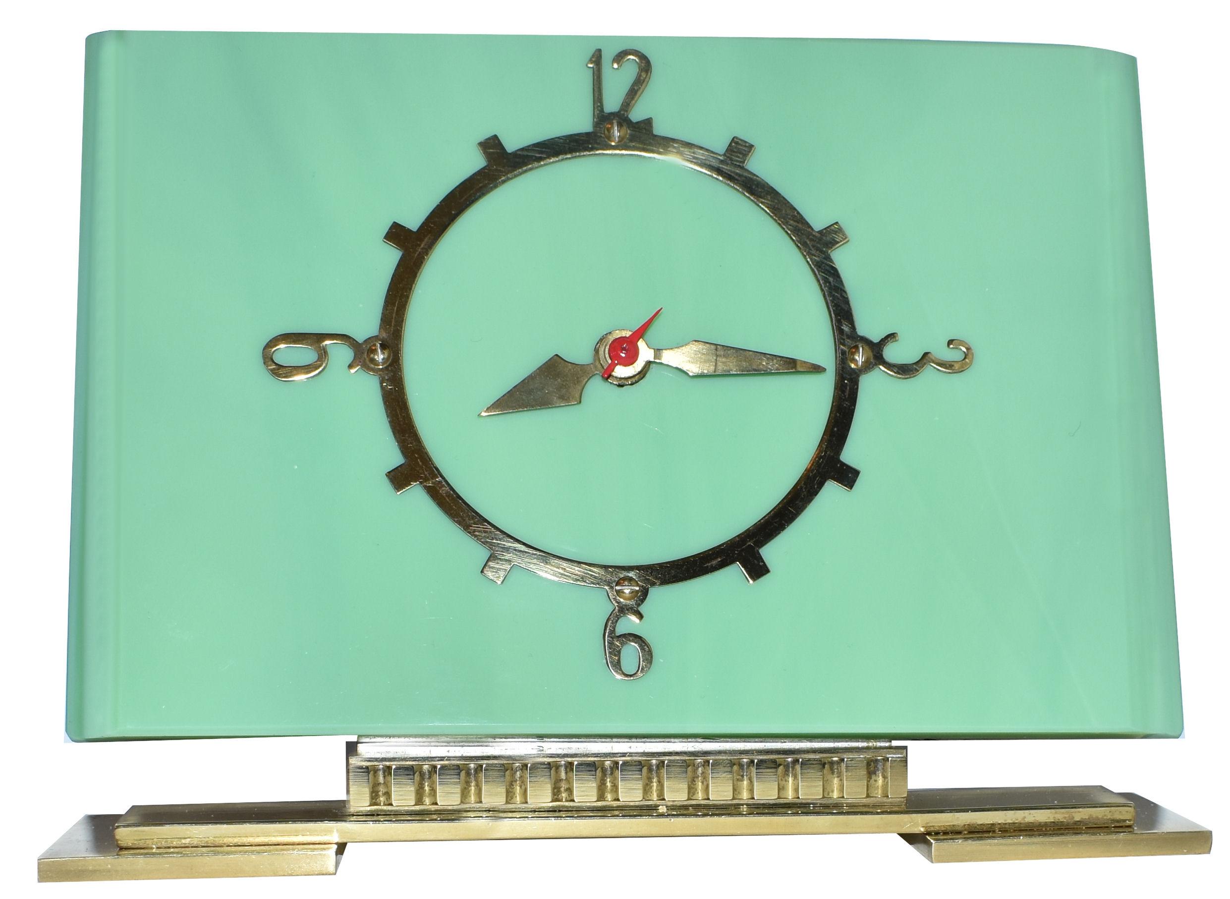 Fabulous 1930s Art Deco modernist mantle clock by British electric meters ltd. Thick vitrolite 'deco green' glass clock with highly polished brass plinth and dial. Runs on electric, works perfectly and has a silent motor so no tics. Lovely condition