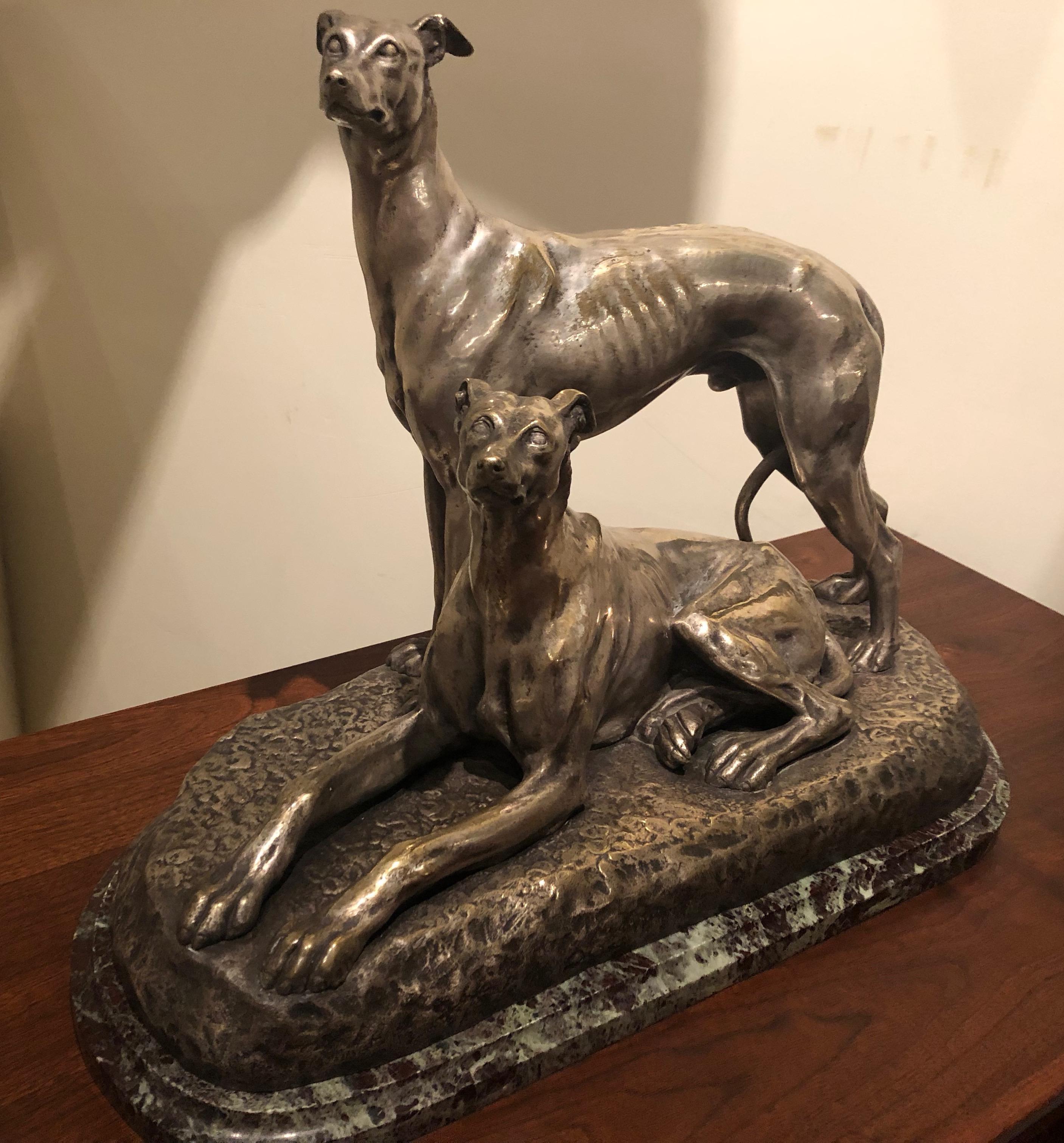 Two Greyhound dogs, a nickeled bronze sculpture by French artist Suzanne Bizard. Stylized figural and accurate rendering portraying a pair of greyhound dogs relaxed in situ. Stunning quality showing the many physical characteristics of this breed:
