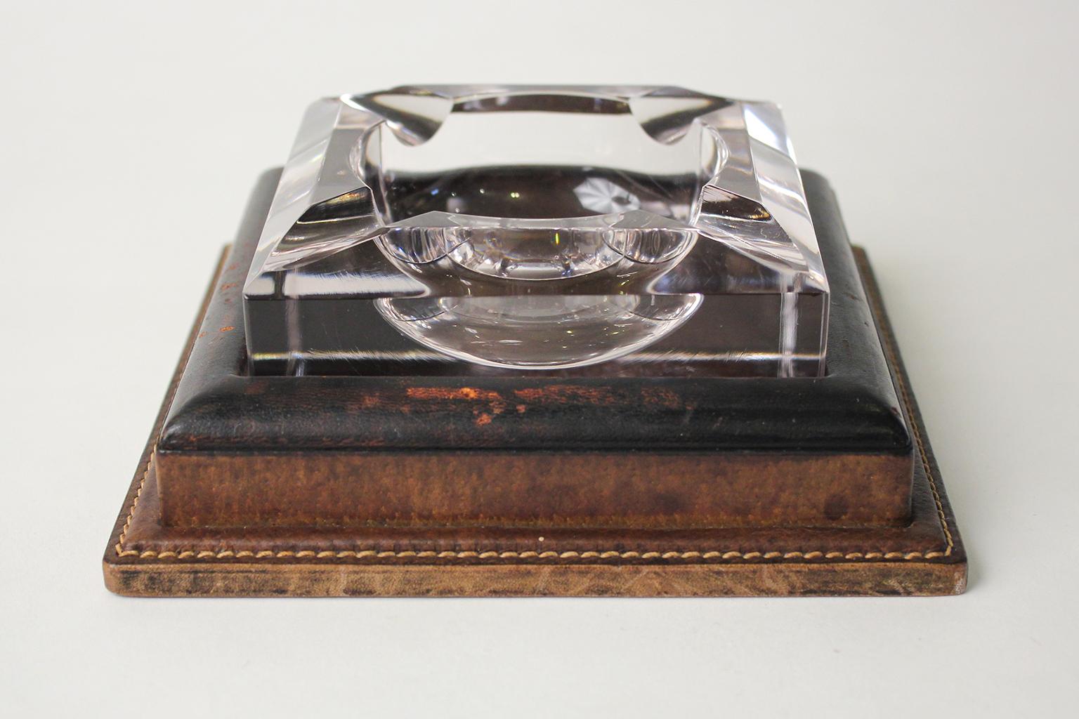 Wonderful Art Deco Gucci leather wrapped and crystal cigar or cigarette ashtray. Made in Italy and is signed on the bottom. Larger size. In very nice original condition. Would be a great addition to any cigar lounge or soothing area.