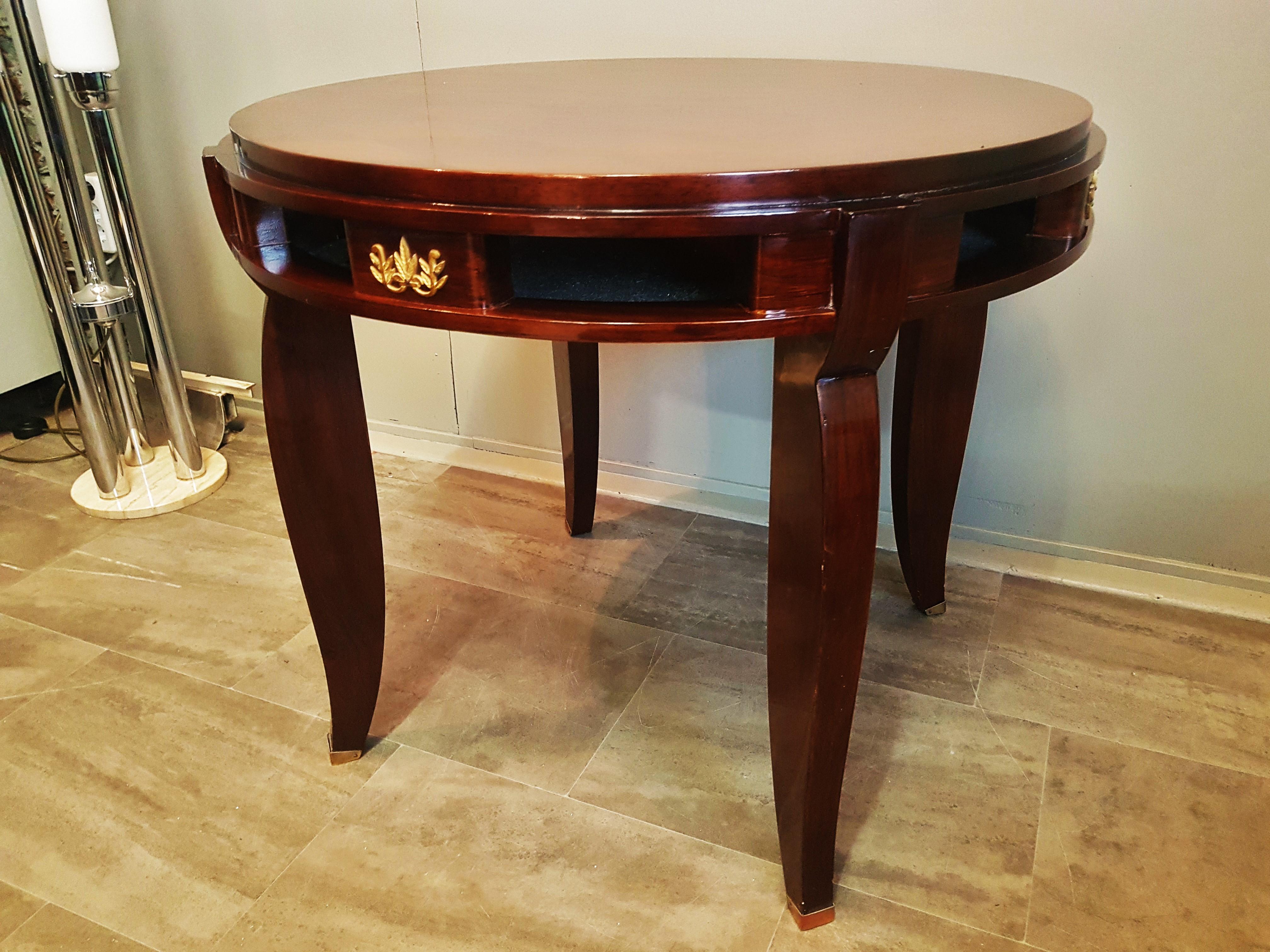Art Deco gueridon center table by Jules Leleu, France, 1930.

Mahogany wood, marquetry. 4 floral golden details. 4 brass feet sabots.

Fully restored. High gloss laquor, hand polished.



Jules Leleu was a French furniture designer famous