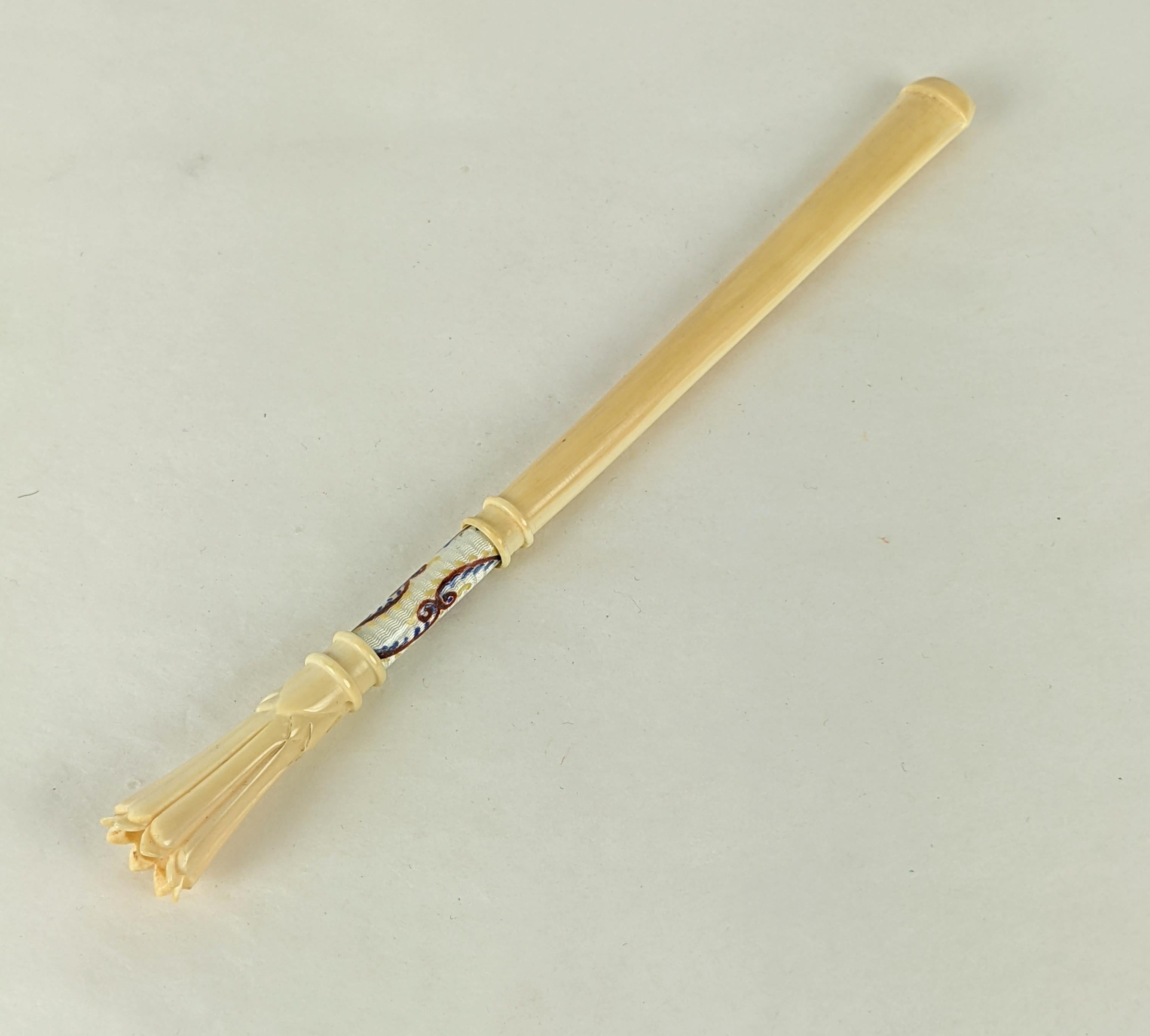 Art Deco Guilloche Enamel and Carved Bone Cigarette Holder with Case. Bone carved cigarette holder with enamel station on sterling in its own wine silk moire case lined in ivory calf leather. Sterling silver tip pin clasp. Appears unused. 
1920's