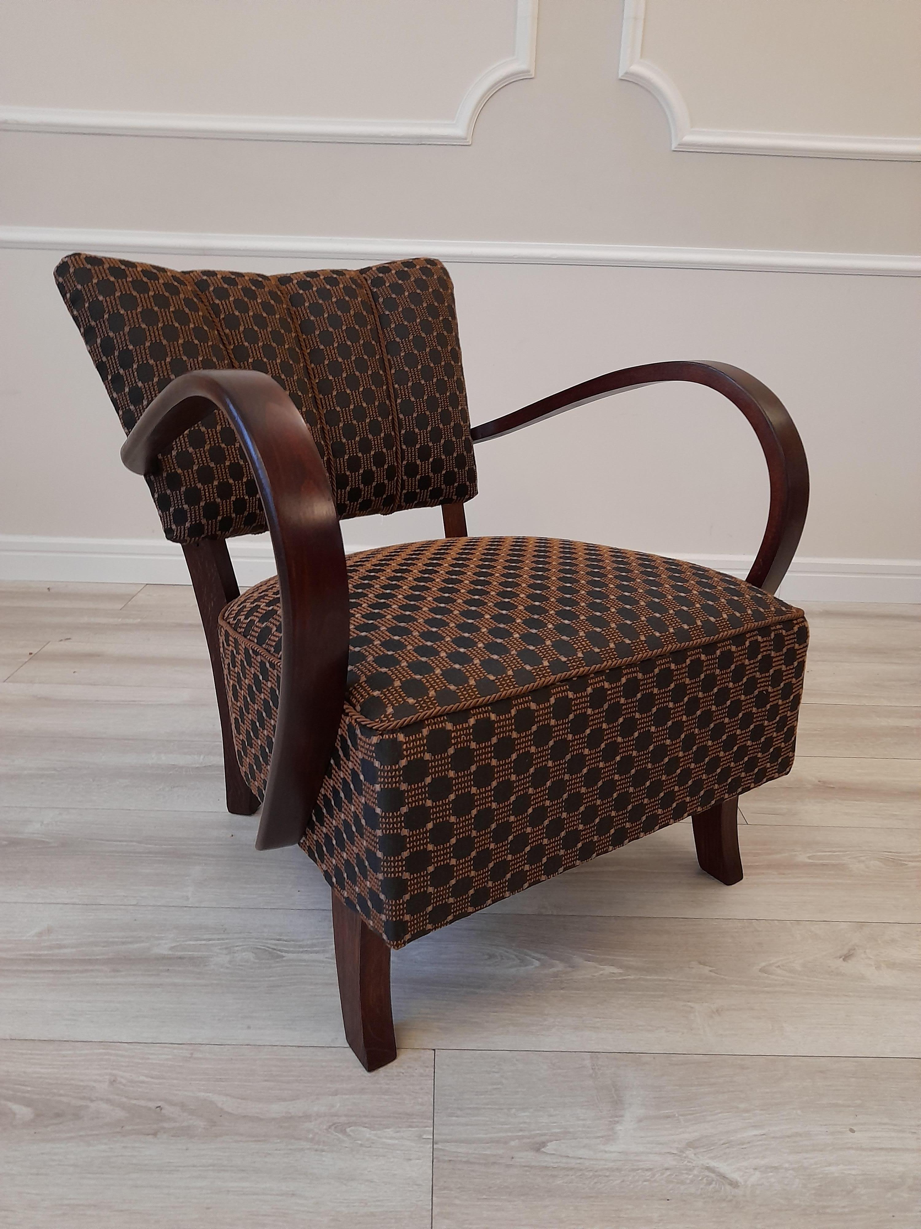 One of the icons of Czech art deco design, armchair model H-237, designed by Jindrich Halabala. The armchair was manufactured in Czechoslovakia in the late 1930s. The structure is made of solid beech bentwood in a warm palisander color, finished