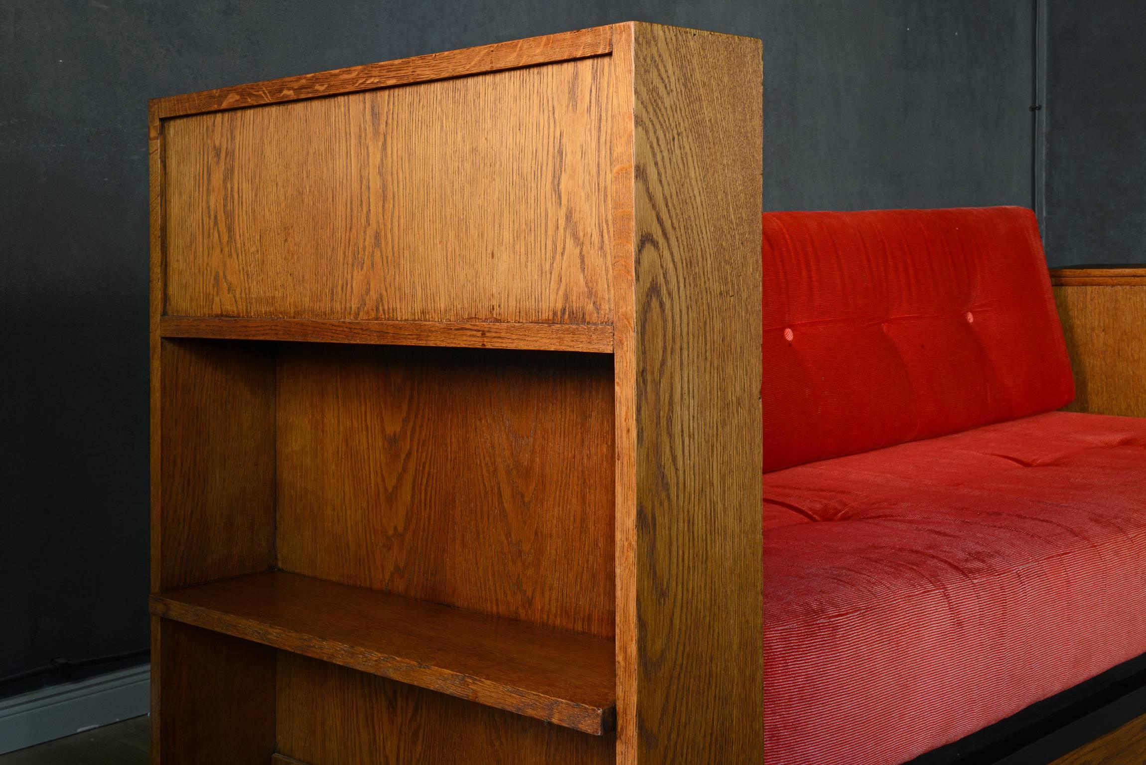 This rare and beautiful Art Deco Haagse School sofa by Jan Brunott. It is made out of solid oak with original ebonized lining. The red corduroy cushions are slightly faded. This sofa can be taken apart for easy transportation. In good original