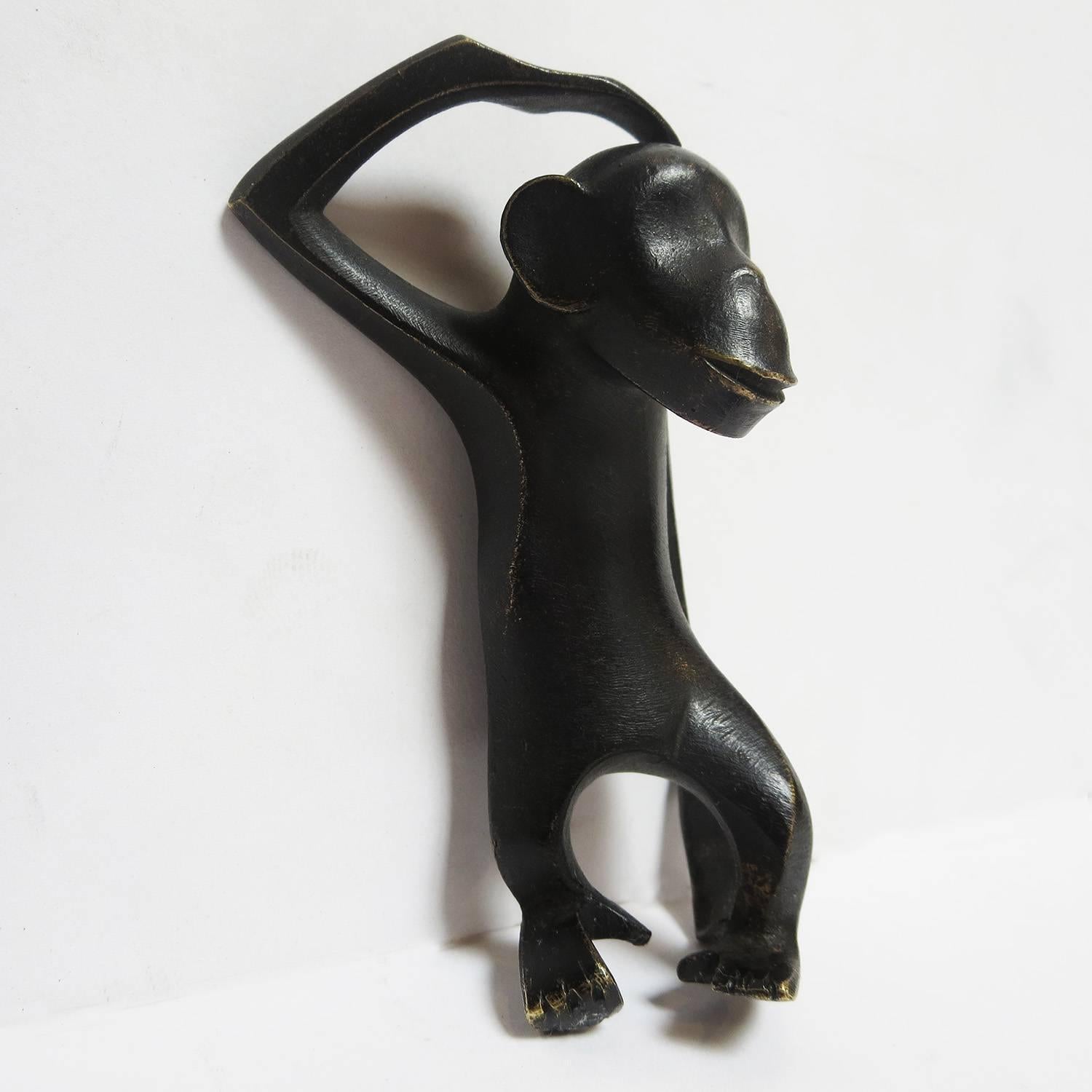This charming monkey was made by the Hagenauer workshops in Vienna Austria in the 1930s. Karl Hagenauer was fascinated with the exotic images of African people and animals, and used them generously in his works. The monkey is in excellent original