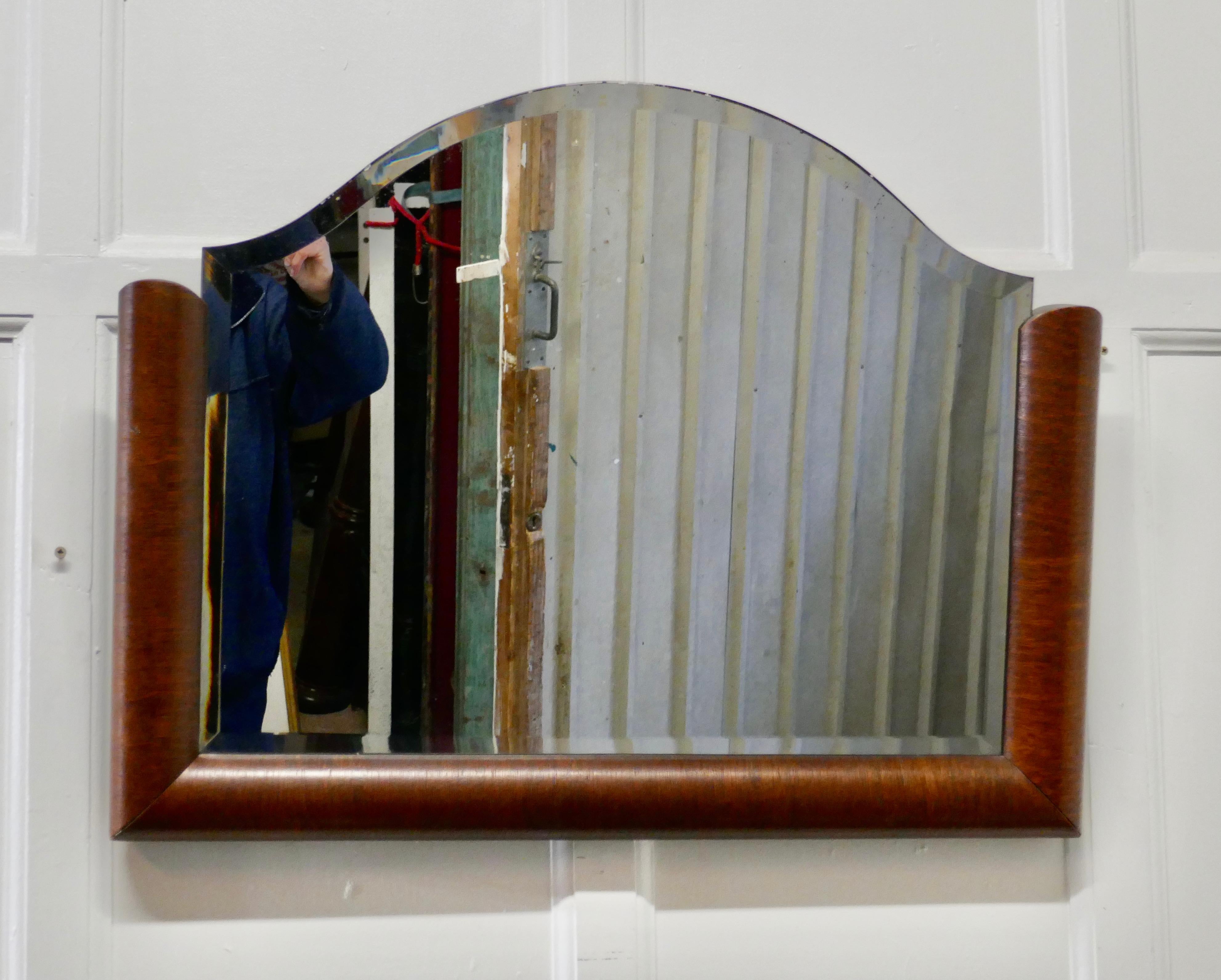 Art Deco half frame mahogany mirror 
 
This is a stylish Art Deco mirror, the mirror has a 3” D shaped mahogany frame it is in good condition and has the original Arched bevelled glass, this has very slight marks at the top but nothing very