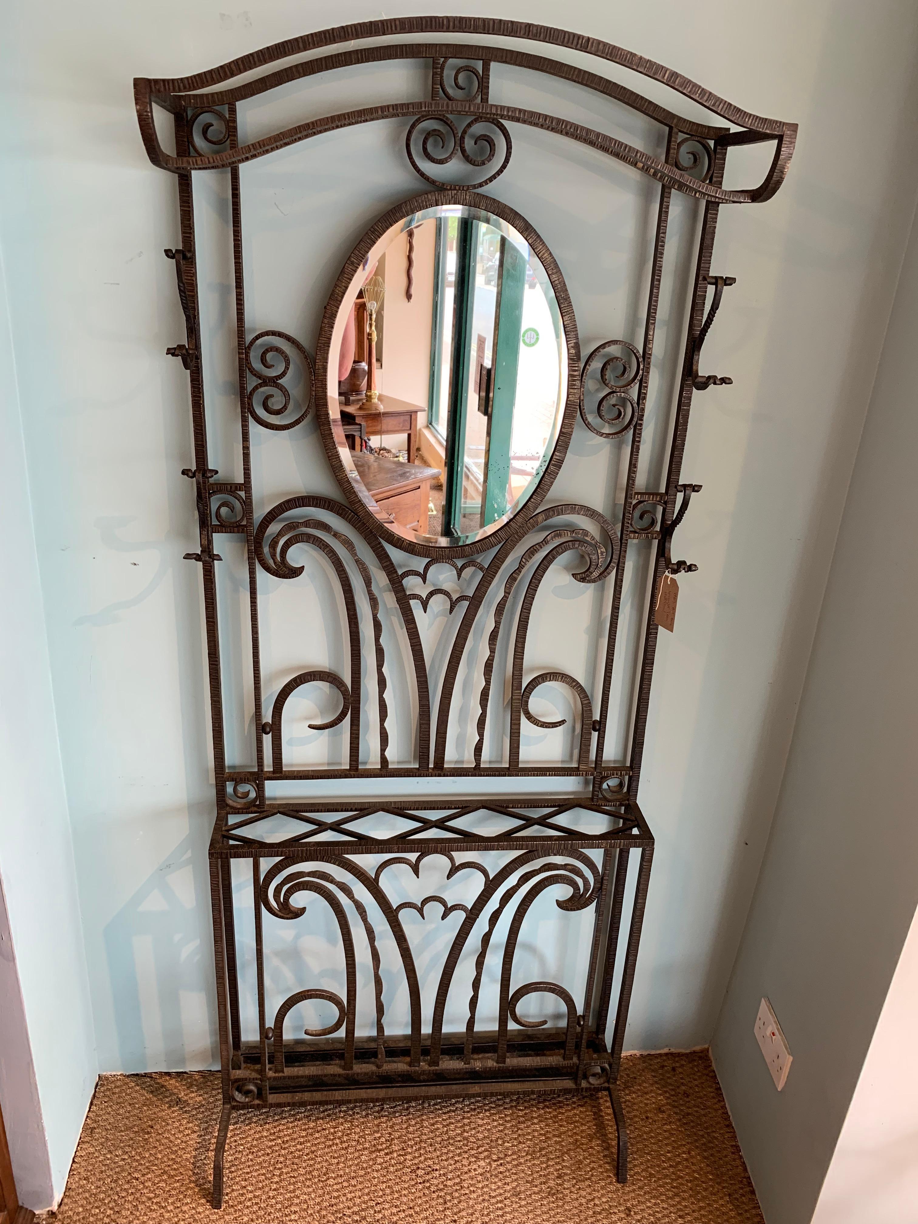 Fabulous, Art Deco period wrought iron hat stand 

Dating to around the 1930s with original mirror and drip tray 

Measures: Height 77 inches
Width 31 inches
Depth 11 inches.