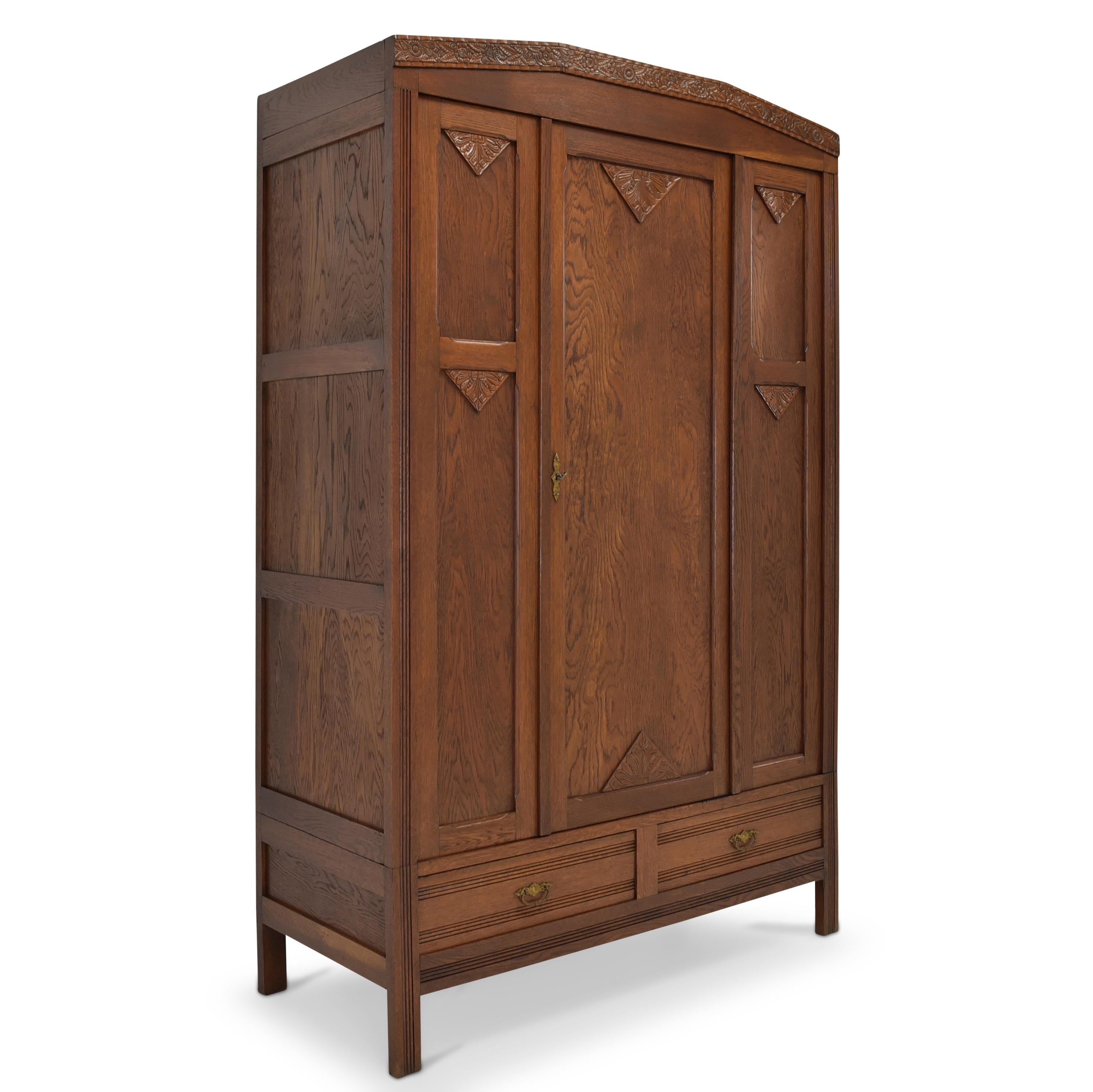 Hallway closet restored Art Deco circa 1930 oak closet

Features:
Single-door model with two drawers and clothes rail
Geometric shape
Abstract carving applications
Very nice patina
Extraordinary model
The cabinet can be