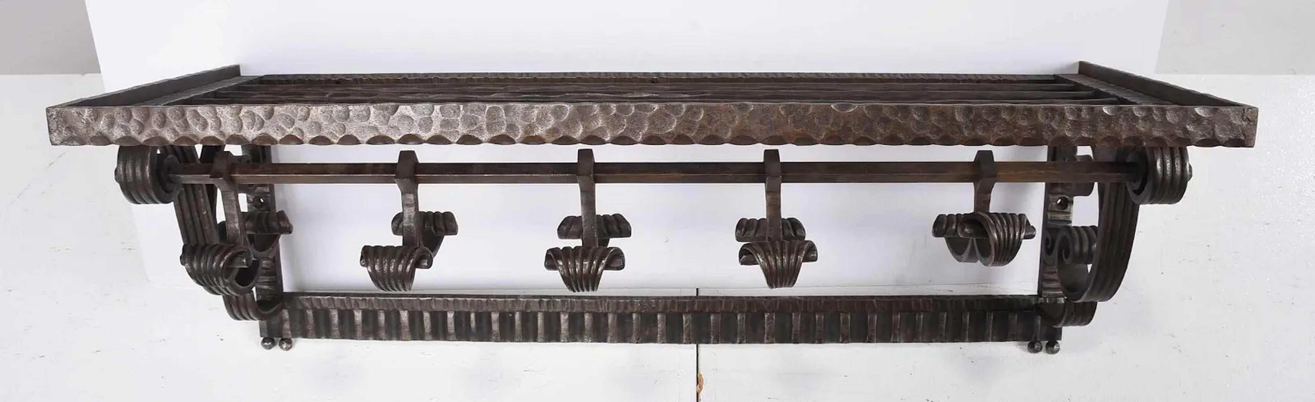 Art Deco hammered wrought iron wall mounted coat rack by Paul Kiss with adjustable coat hooks: France: circa 1930 Signed 
