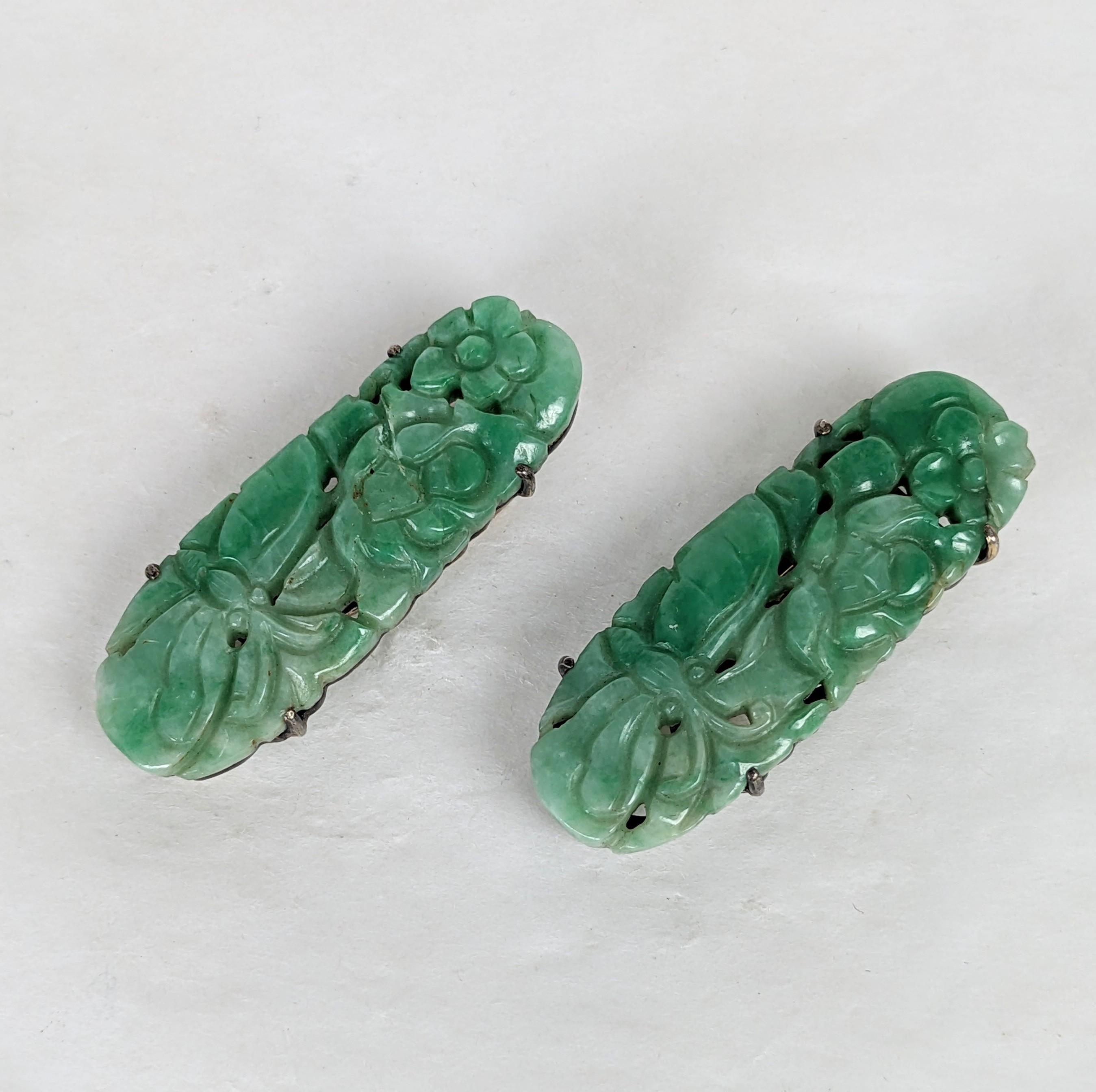 Pair of Art Deco Hand Carved Jade Dress Clips/Earrings from the 1920's. Delicately hand carved with butterflies within flowers. Each is set in sterling silver. Can be used on a neckline, as a pendant or as elegant earrings with foam pads. Each 1.5